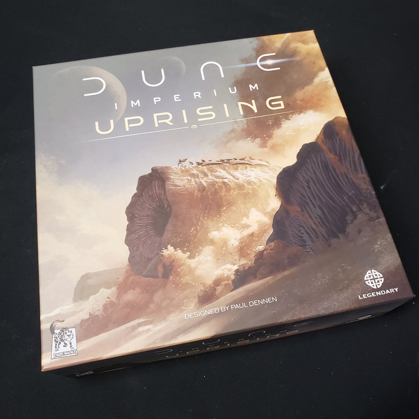 Image shows the front cover of the box of the Dune Imperium: Uprising board game