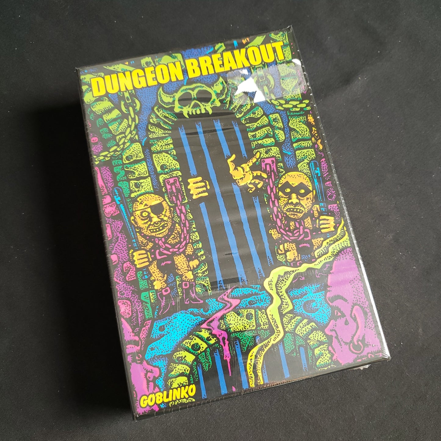 Image shows the front cover of the box of the Dungeon Breakout card game