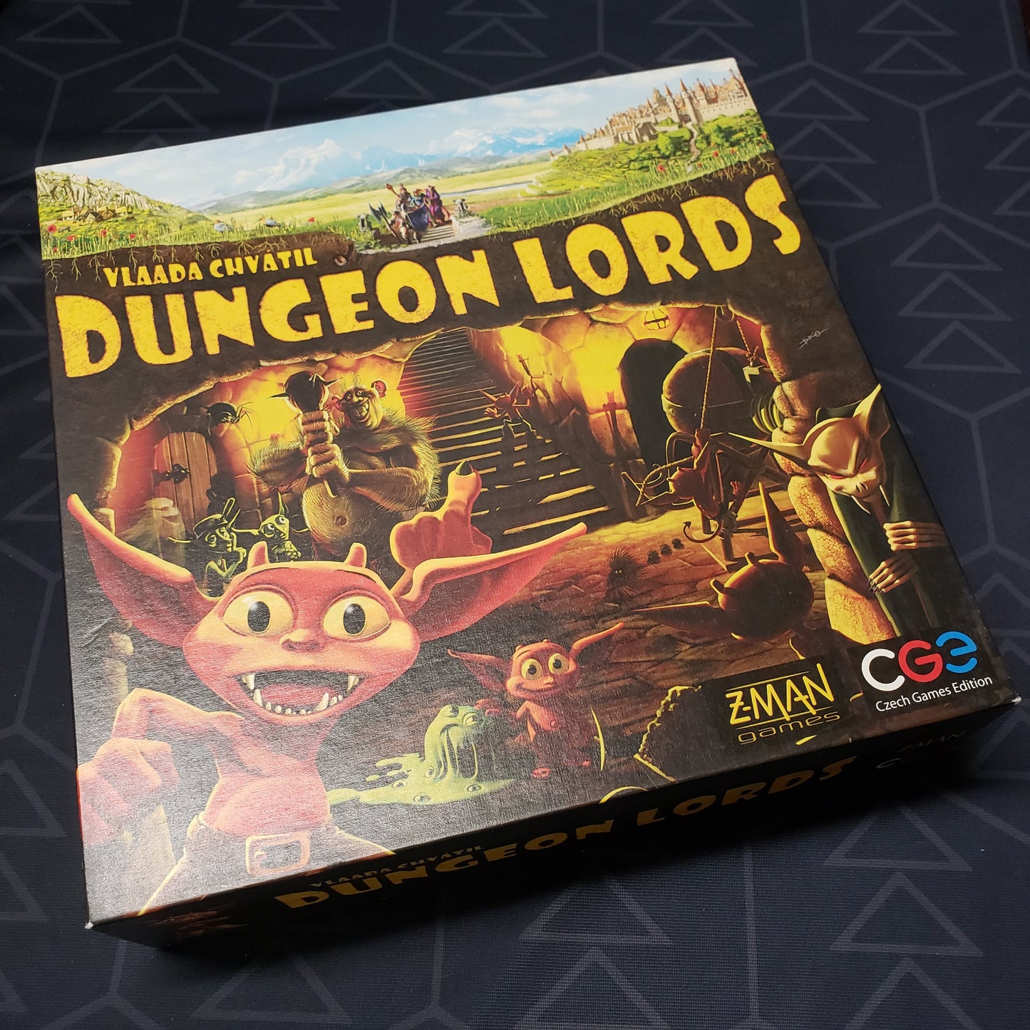Image shows the front cover of the box of the Dungeon Lords board game