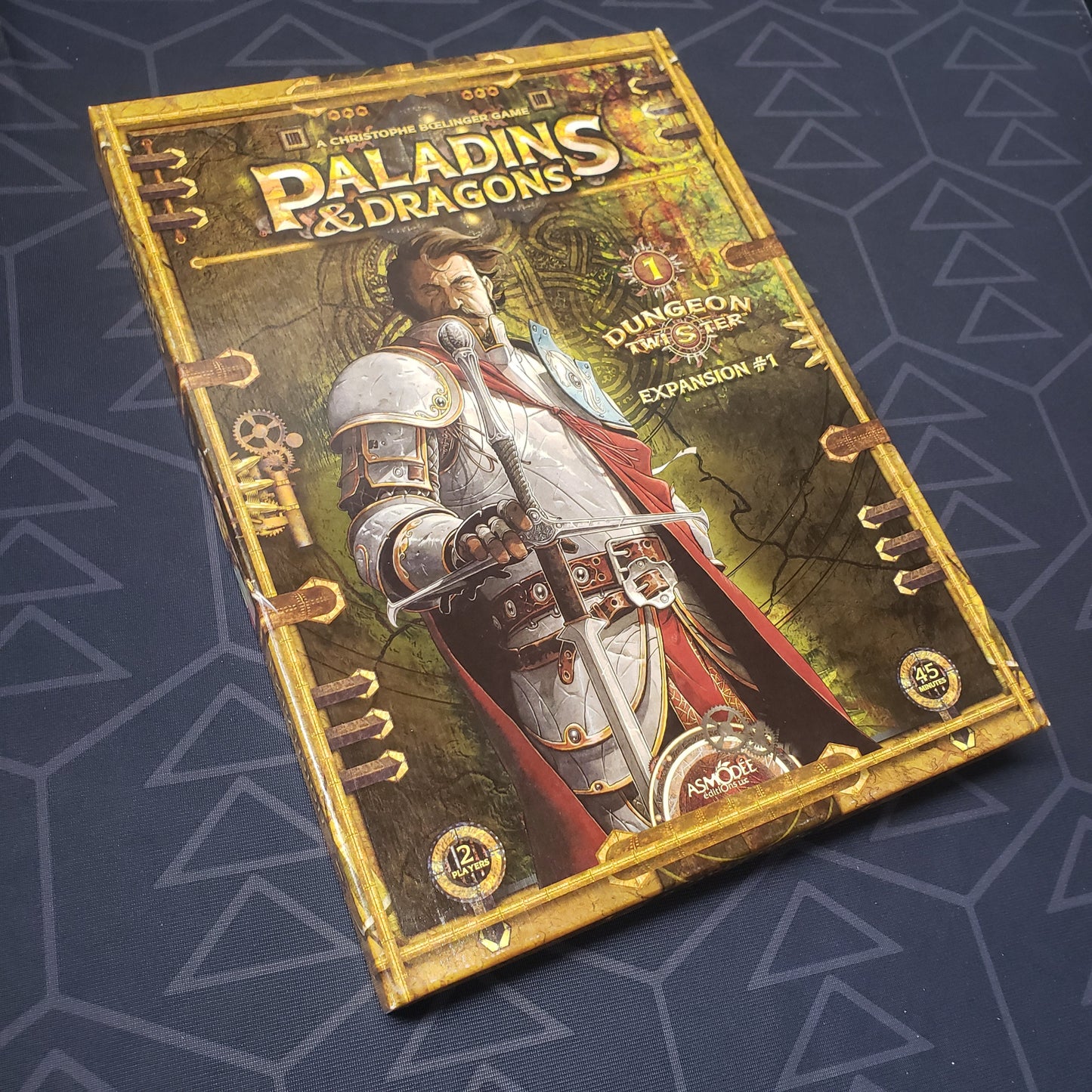 Image shows the front cover of the box of the Paladins & Dragons expansion for the board game Dungeon Twister
