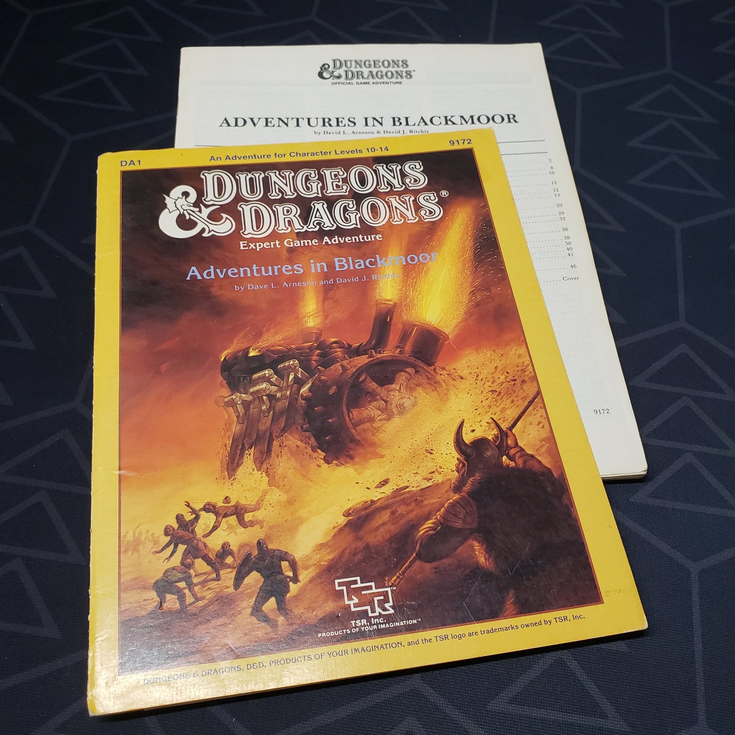 Image shows the front cover of the folio for the Adventures in Blackmoor adventure module for the roleplaying game Dungeons & Dragons: First Edition, with the booklet fanned out
