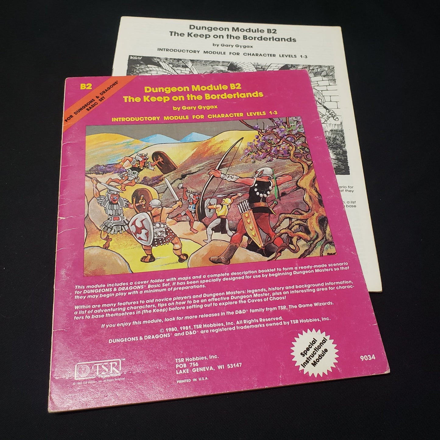 Image shows the front cover of the folio & the booklet of the Keep on the Borderlands adventure module for the roleplaying game Dungeons & Dragons: First Edition