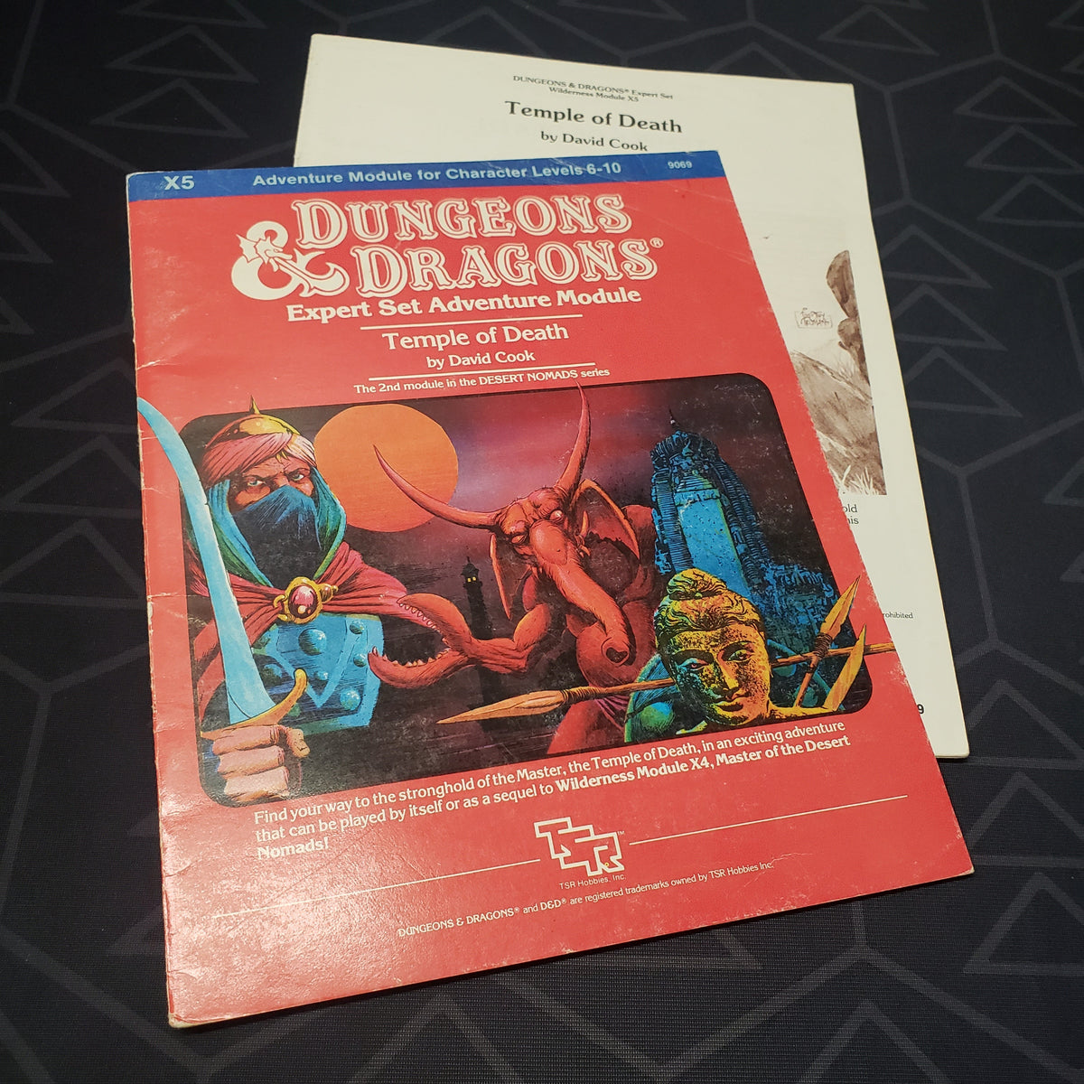 Image shows the front cover of the folio for the Temple of Death adventure module for the roleplaying game Dungeons & Dragons: First Edition, with the booklet fanned out