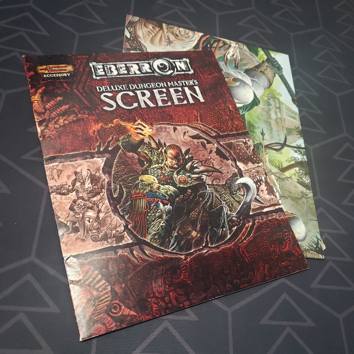 Image shows the front cover and fanned-out screen for the Deluxe Eberron Dungeon Master's Screen for the roleplaying game Dungeons & Dragons 3.5E