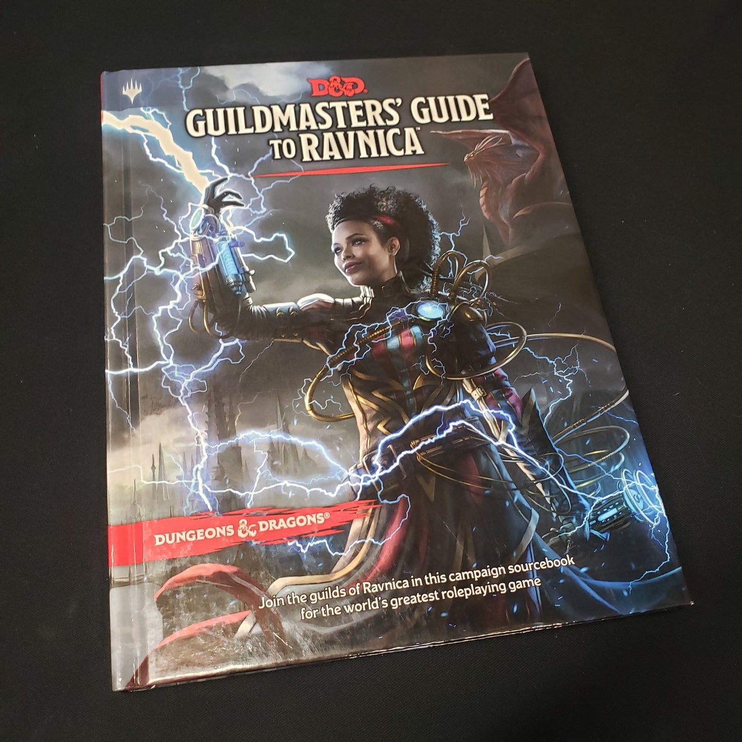 Image shows the front cover of the Guildmasters' Guide to Ravnica book for the roleplaying game Dungeons & Dragons: Fifth Edition