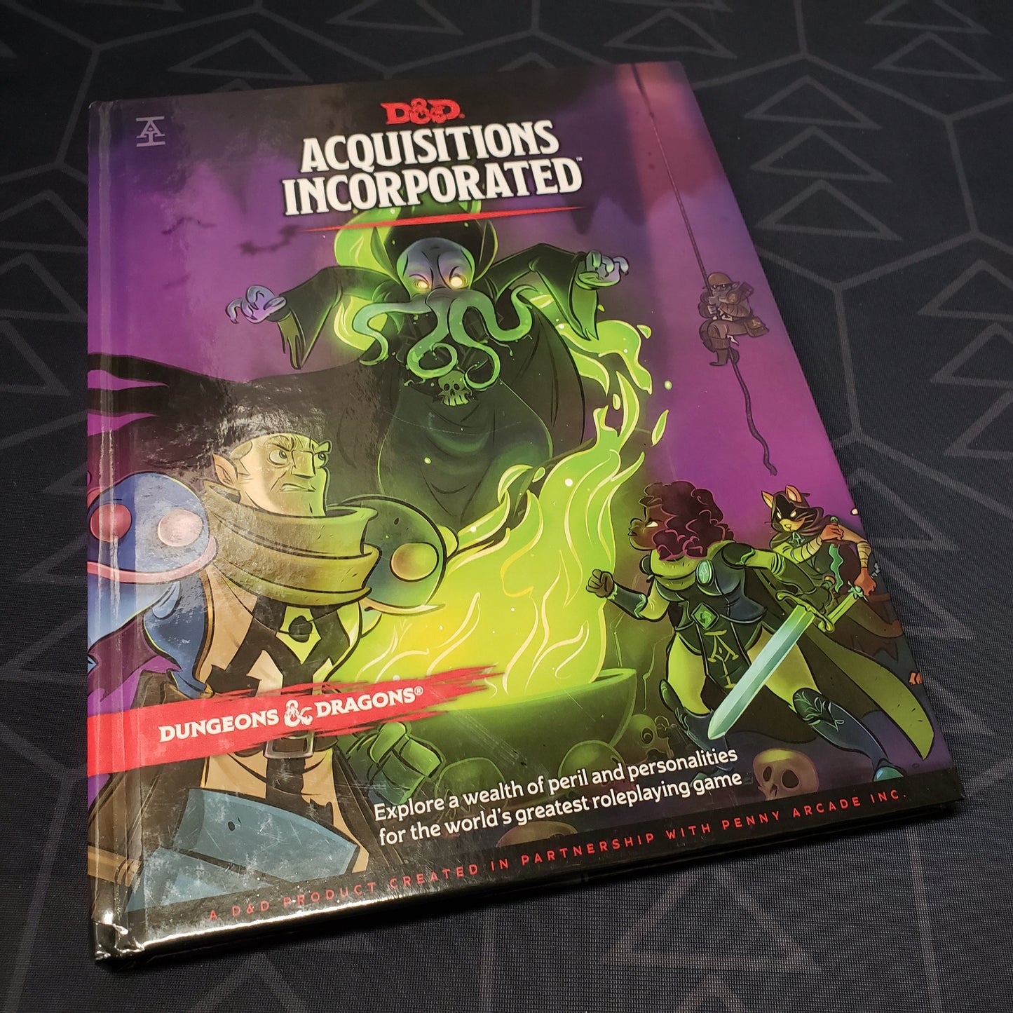 Image shows the front cover of the Acquisitions Incorporated book for the roleplaying game Dungeons & Dragons 5E