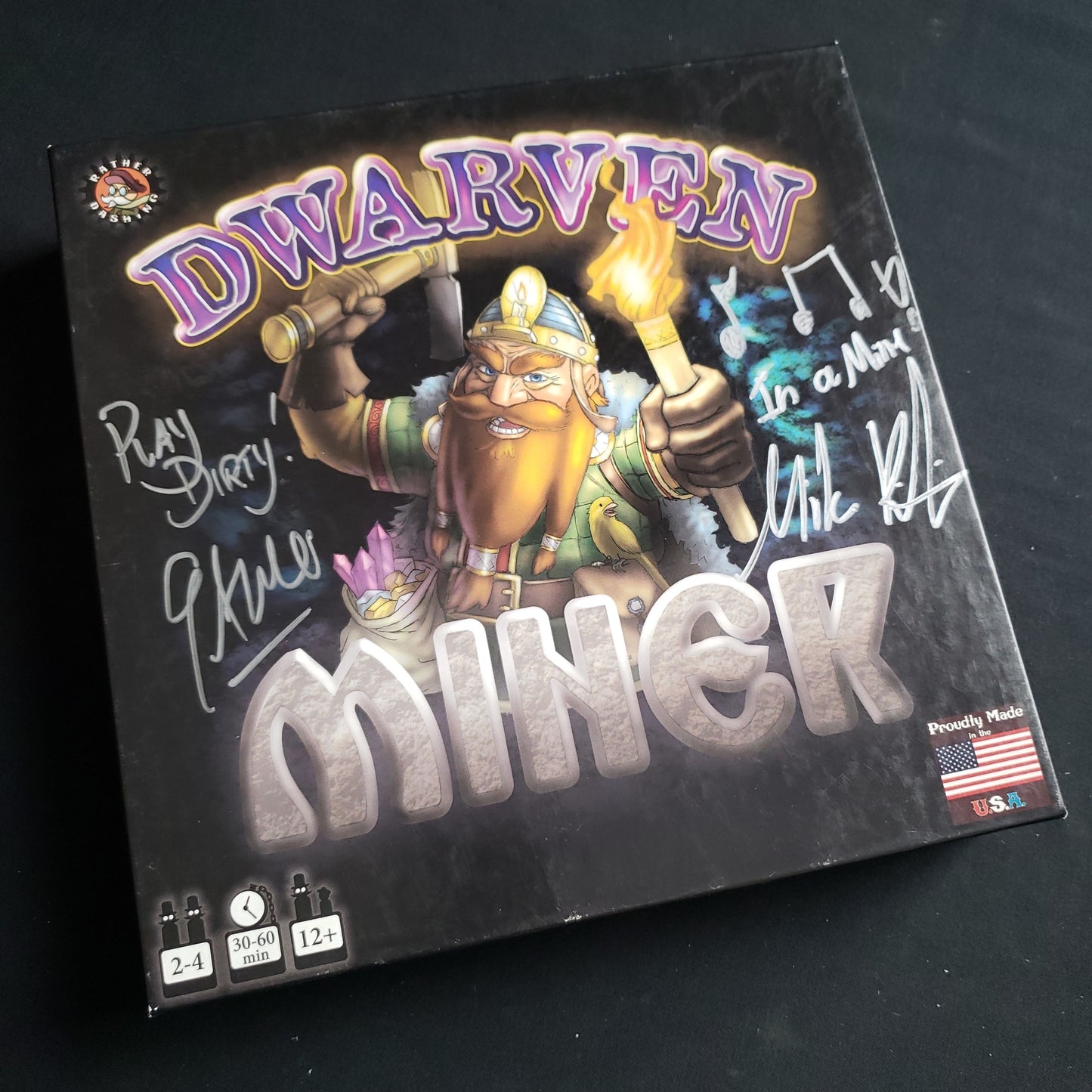 Image shows the front cover of the box of the Dwarven Miner board game