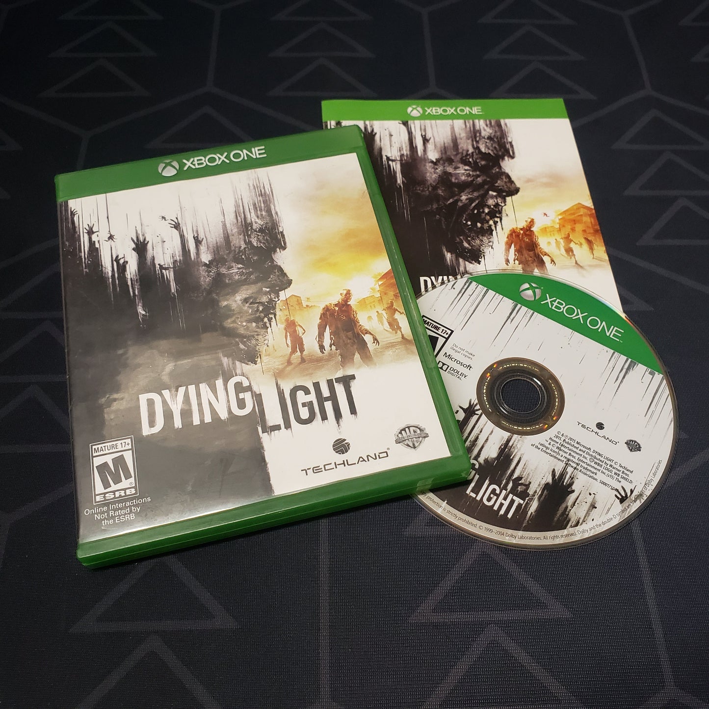 Image shows the case, manual and disc for the video game Dying Light for Xbox One