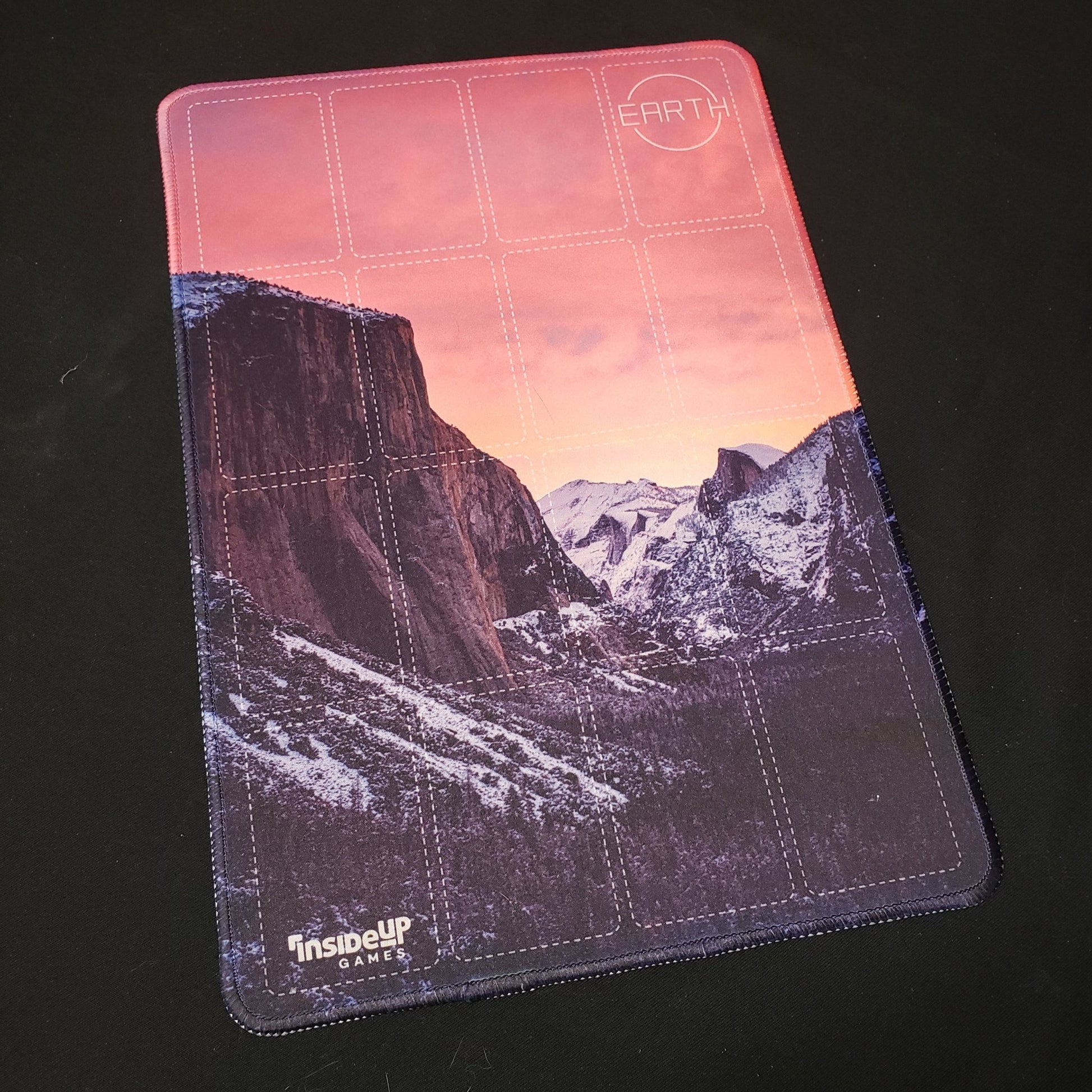 Image shows a playmat featuring the Pink Sky artwork for the board game Earth