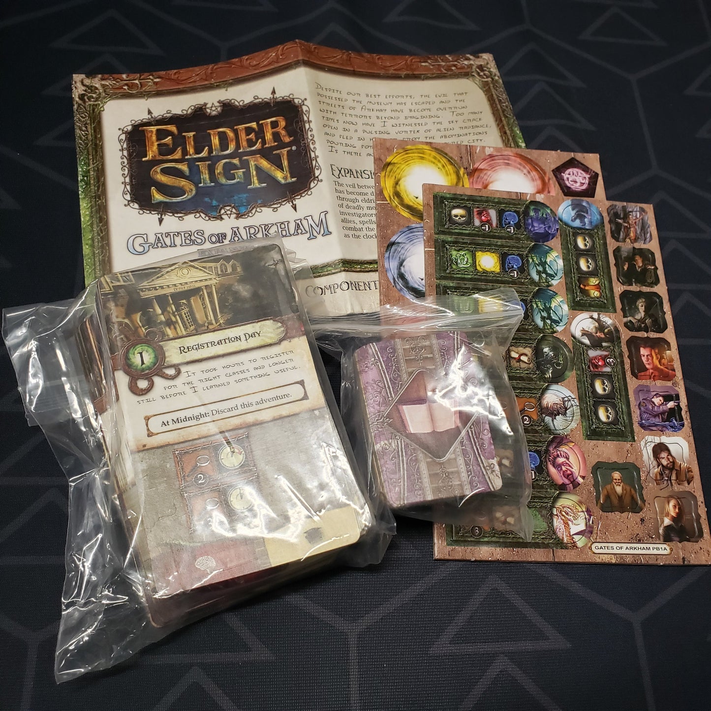 Image shows the instructions & components for the Gates of Arkham expansion from the board game Elder Sign
