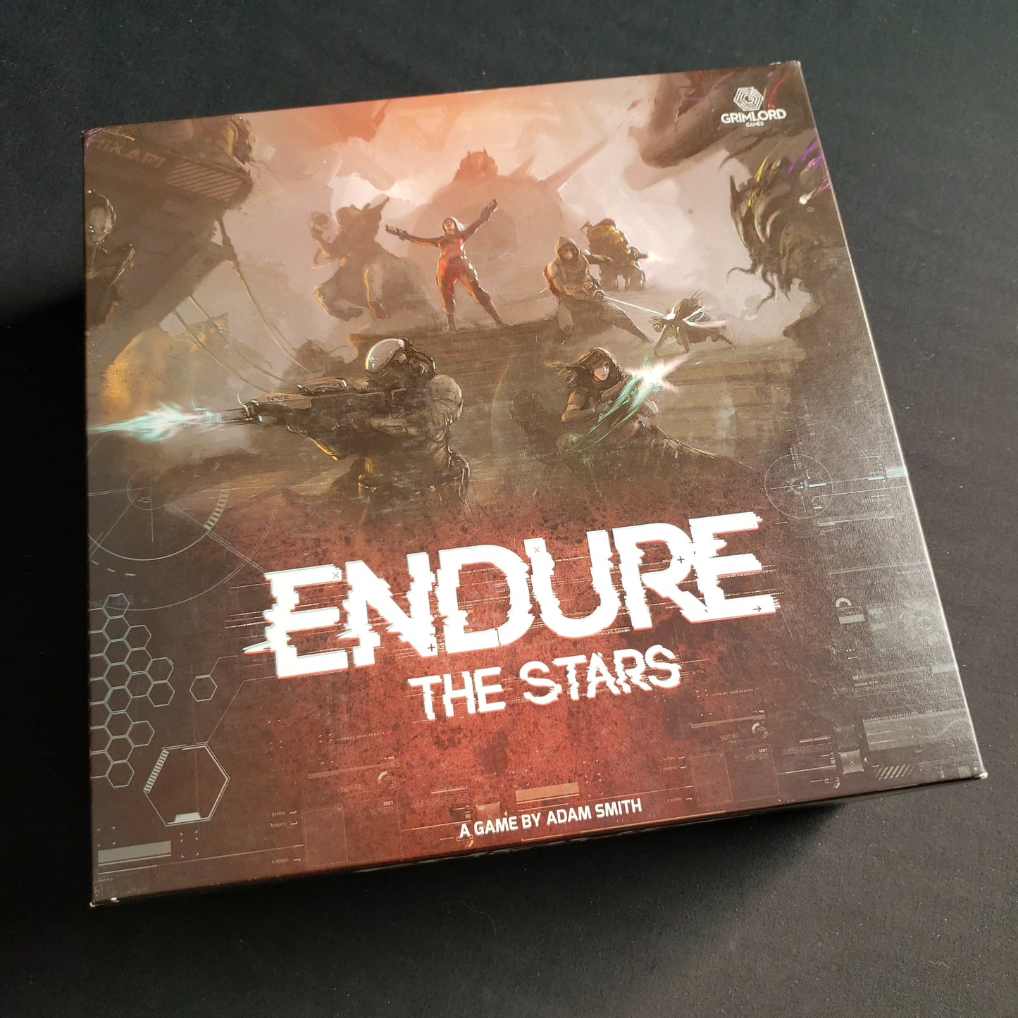 Image shows the front cover of the box of the Endure The Stars board game