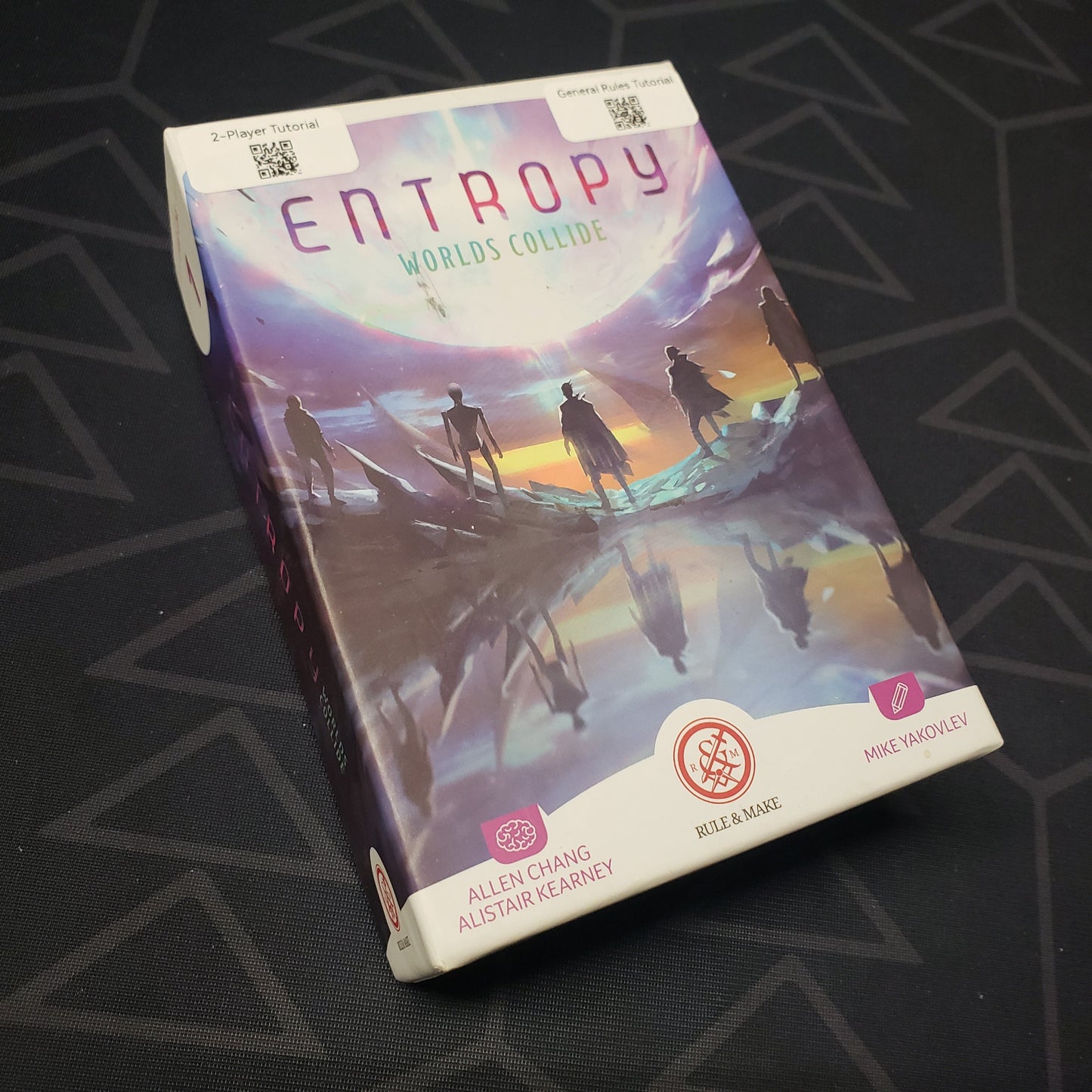 Image shows the front cover of the box for the Entropy: Worlds Collide card game
