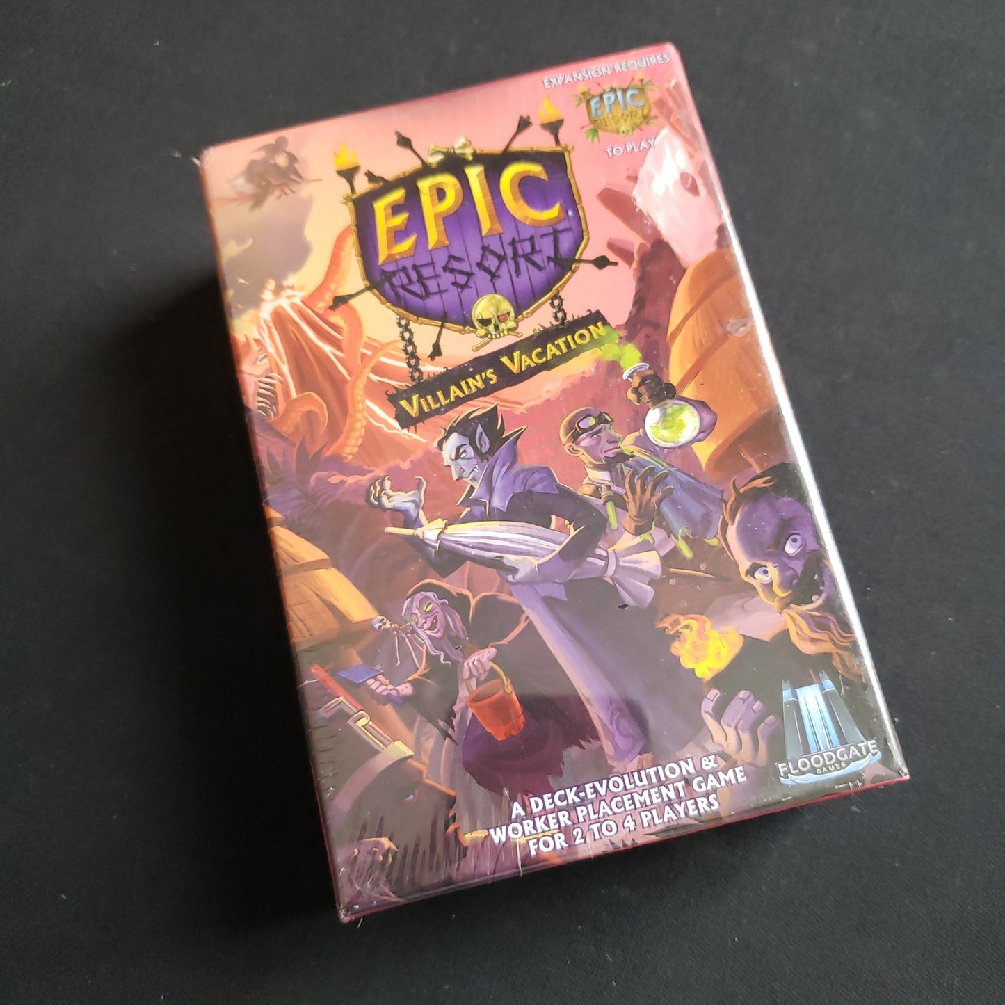 Image shows the front cover of the box of the Villain's Vacation Expansion for the Epic Resort board game