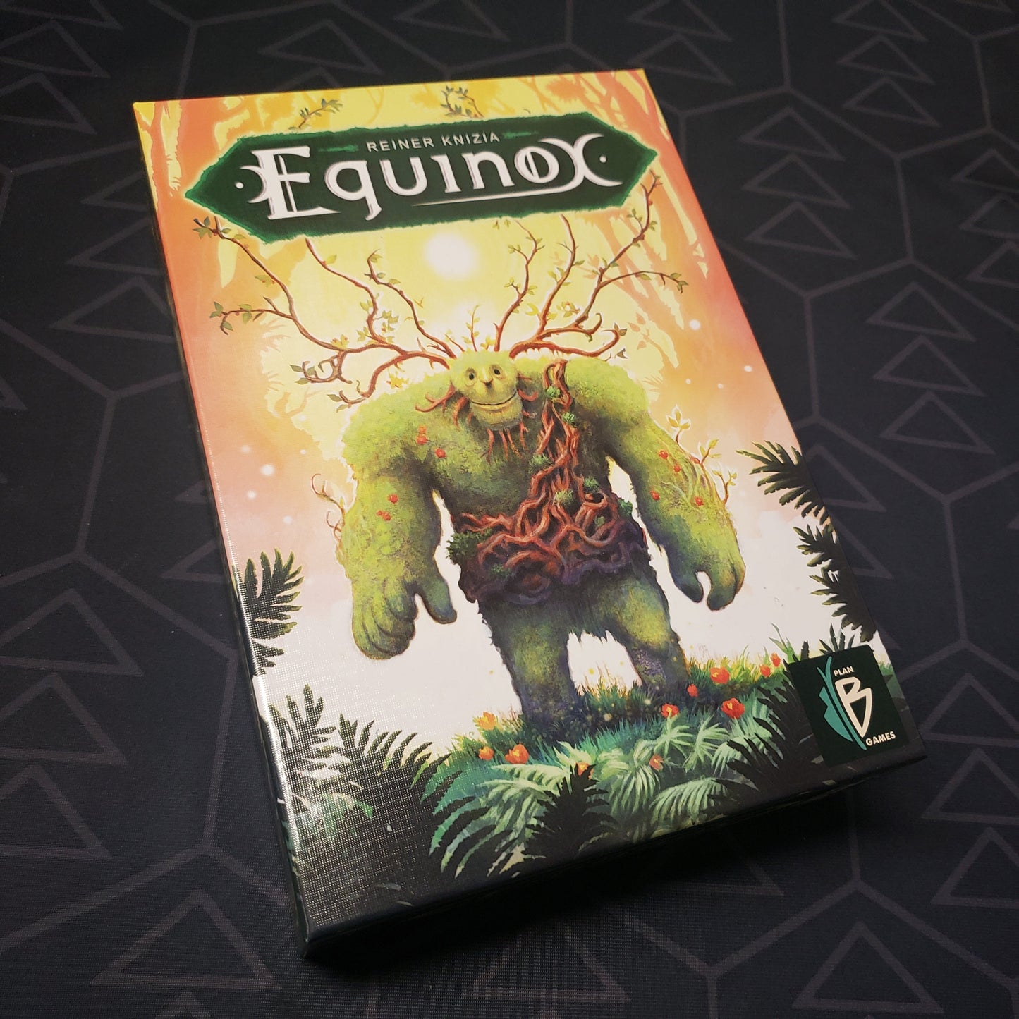 Image shows the front cover of the box of the Equinox board game