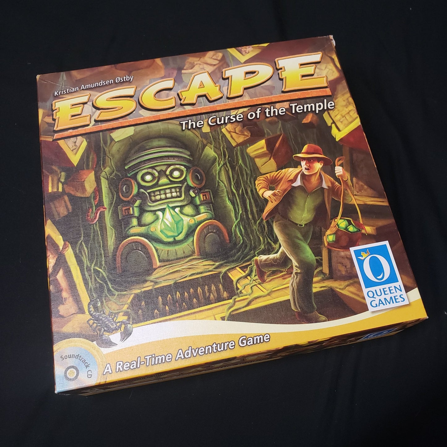 Image shows the front cover of the box of the board game escape: The Curse of the Temple
