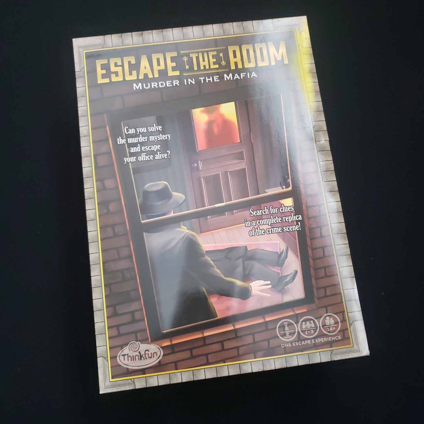 Image shows the front cover of the box of the Escape the Room: Murder in the Mafia puzzle game