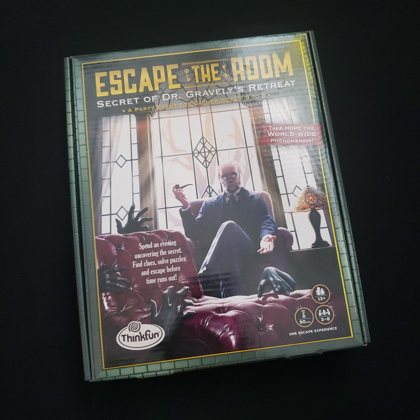 Image shows the front cover of the box of the Escape the Room: Secret of Dr. Gravely's Retreat puzzle game