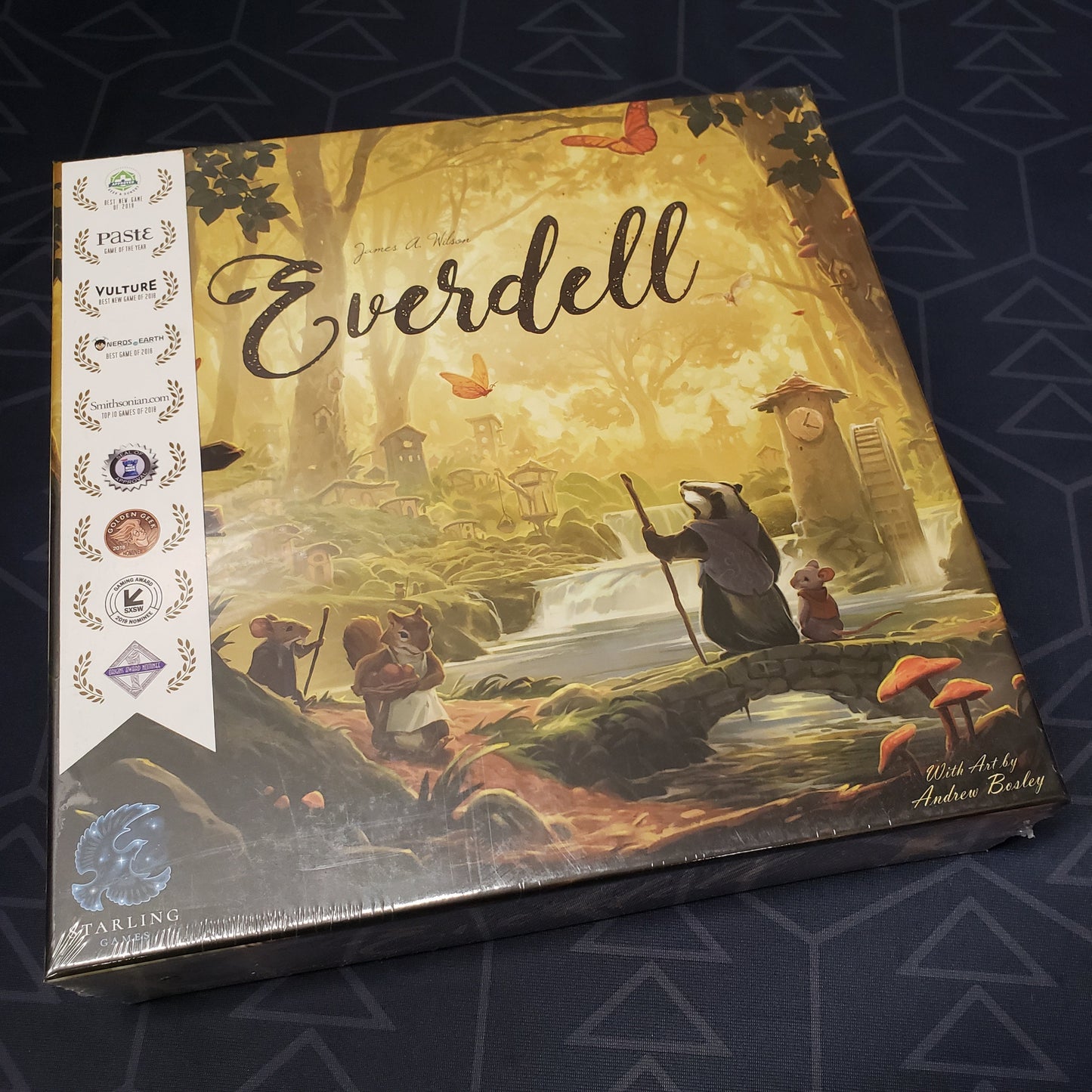 Image shows the front cover of the box of the Everdell board game