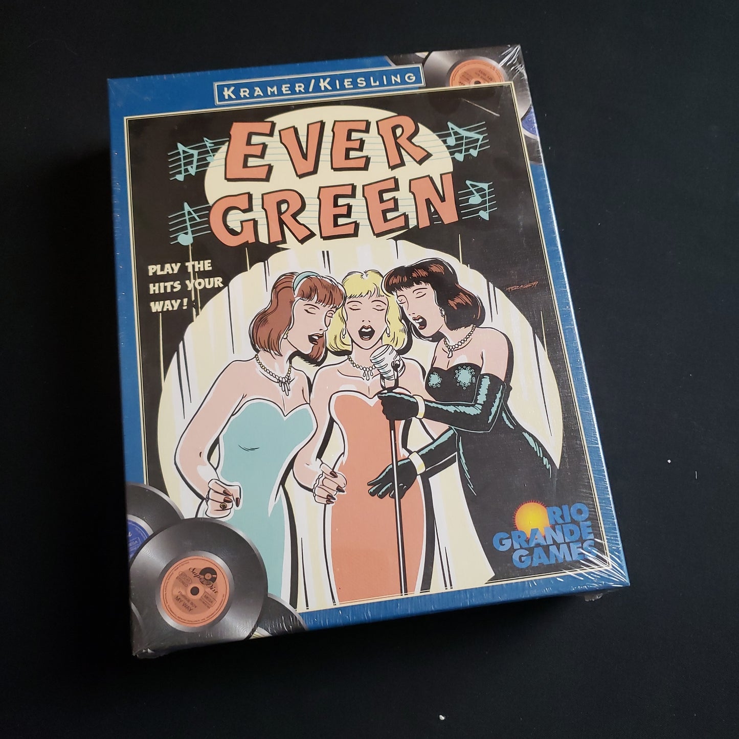Image shows the front cover of the box of the Evergreen board game