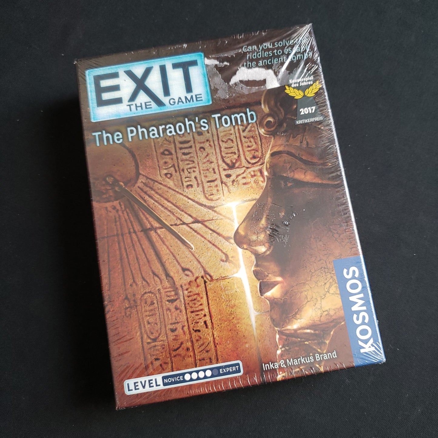 Image shows the front cover of the box of Exit: The Game - The Pharaoh's Tomb