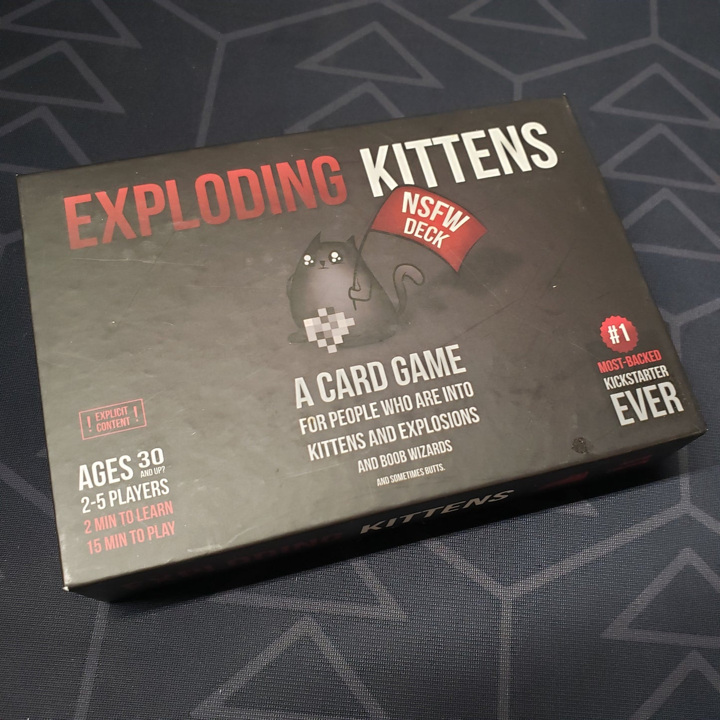 Image shows the front cover of the box of the NSFW Deck for the card game Exploding Kittens