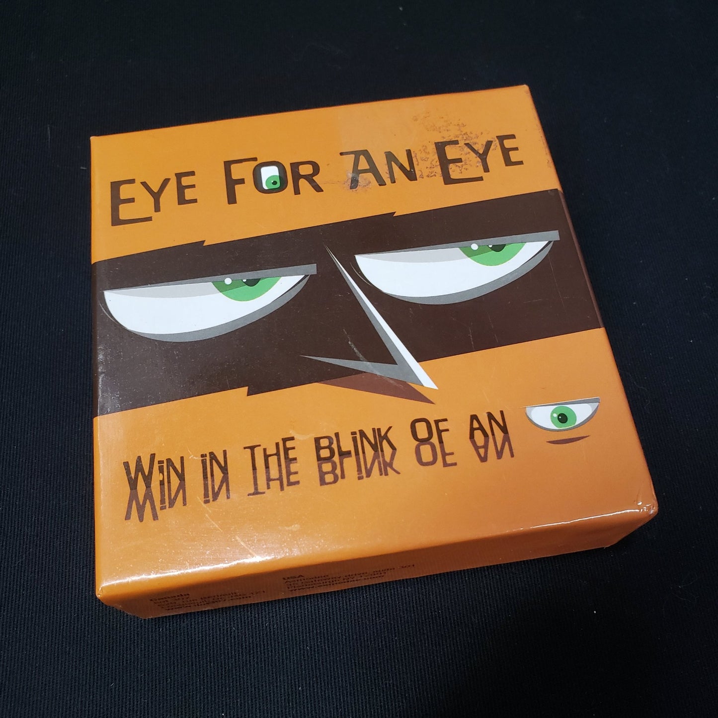 Image shows the front cover of the box of the Eye for an Eye card game