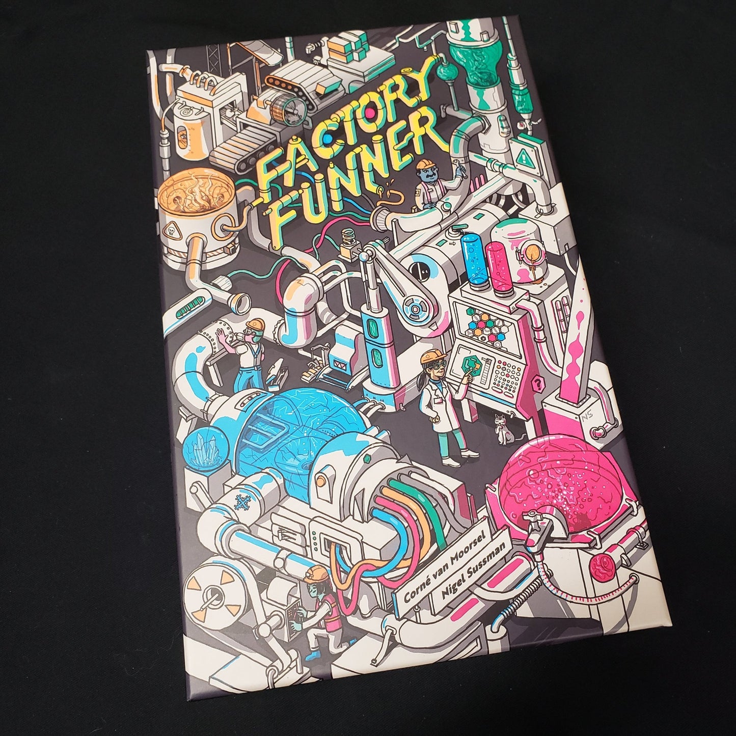 Image shows the front cover of the box of the Factory Funner board game
