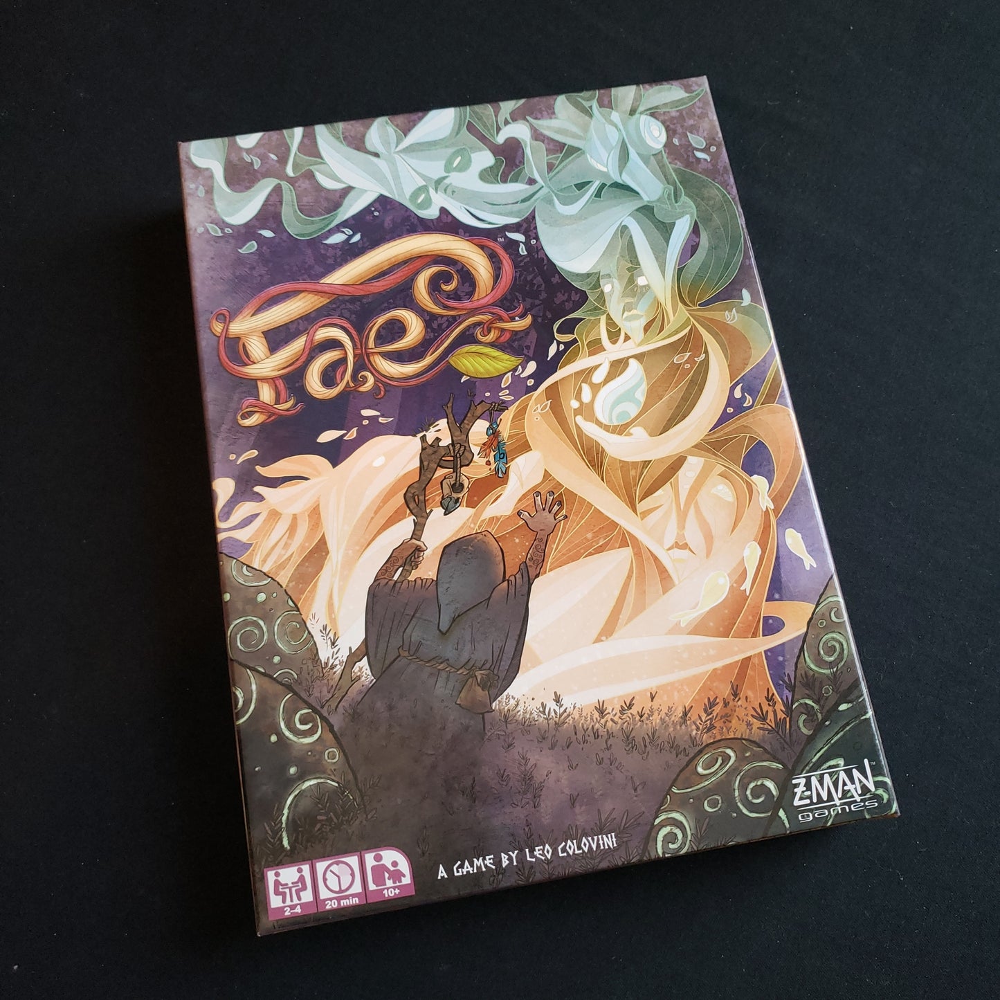 Image shows the front cover of the box of the Fae board game
