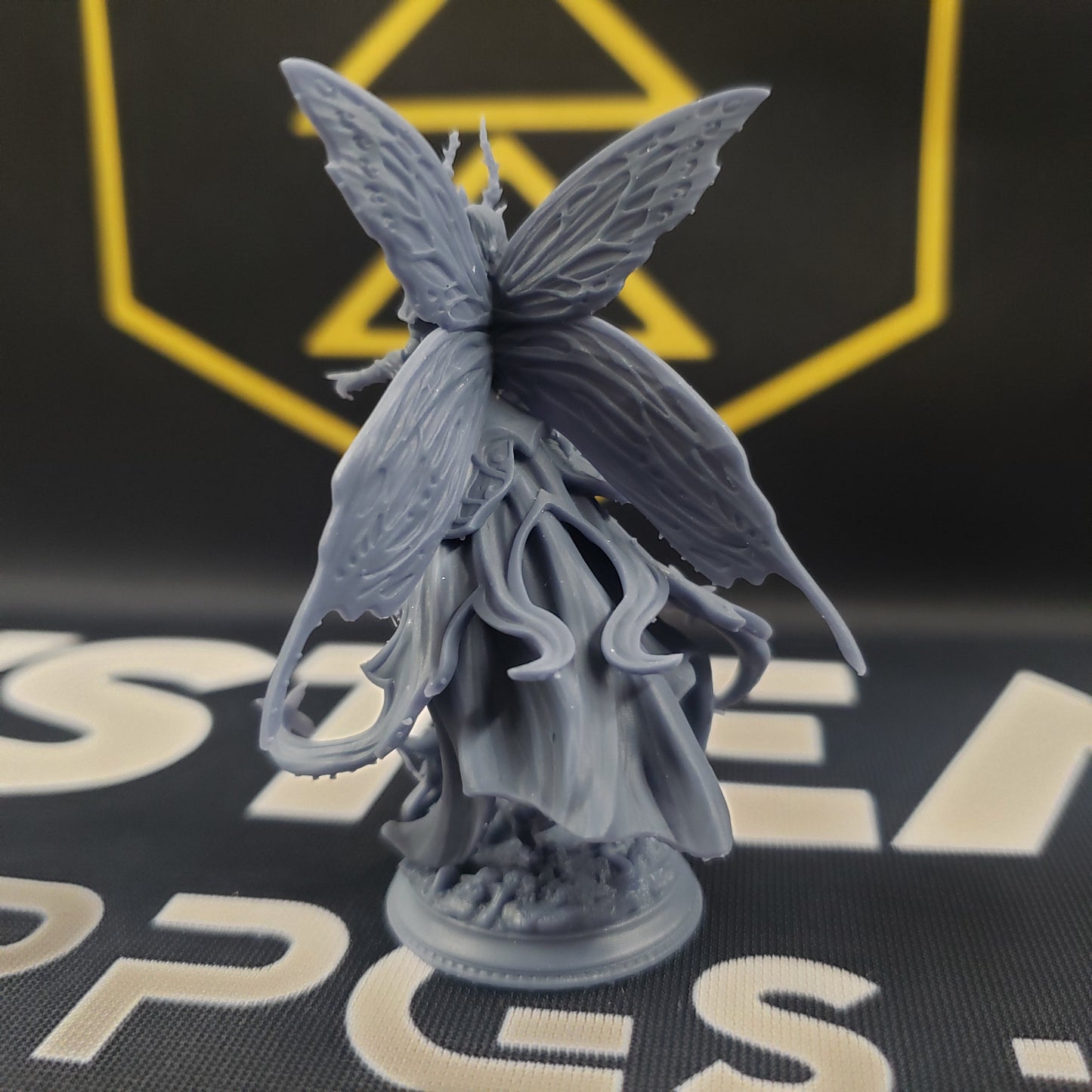 Image shows the back of a fairy queen gaming miniature.