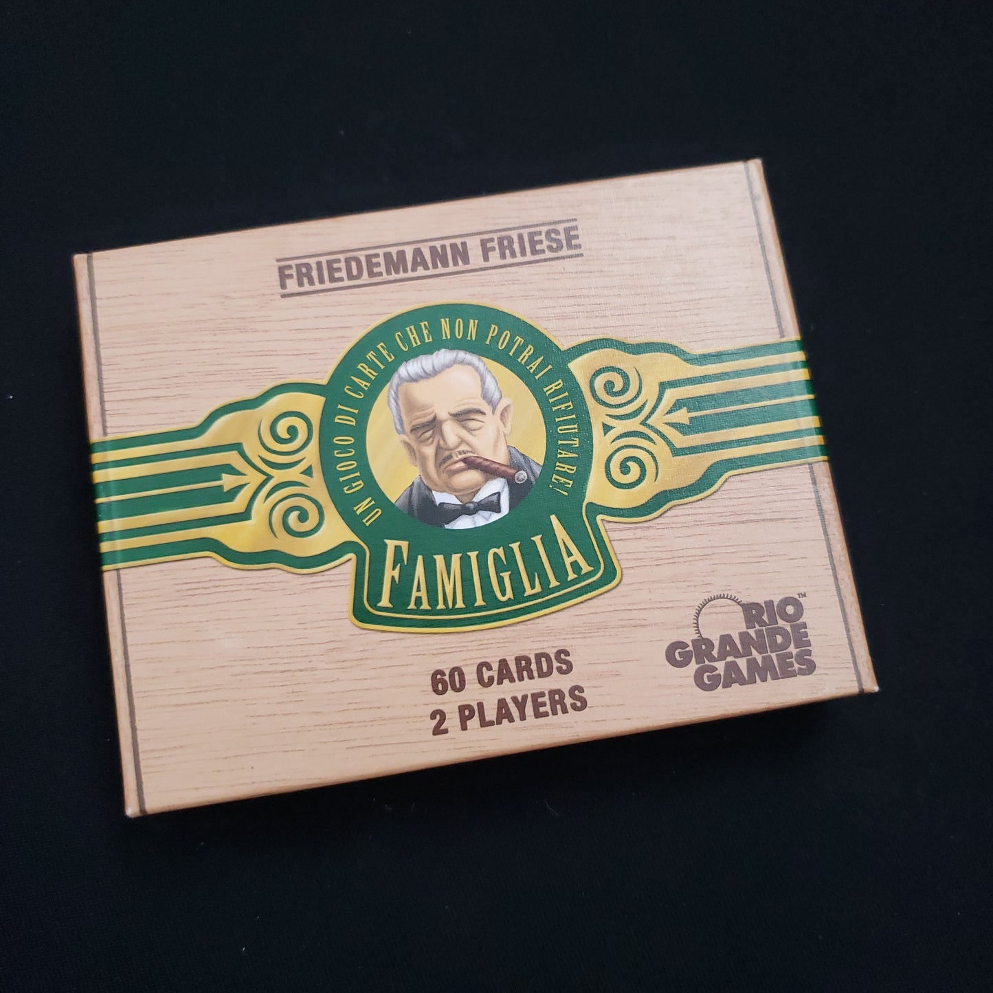 Image shows the front cover of the box of the Famiglia card game