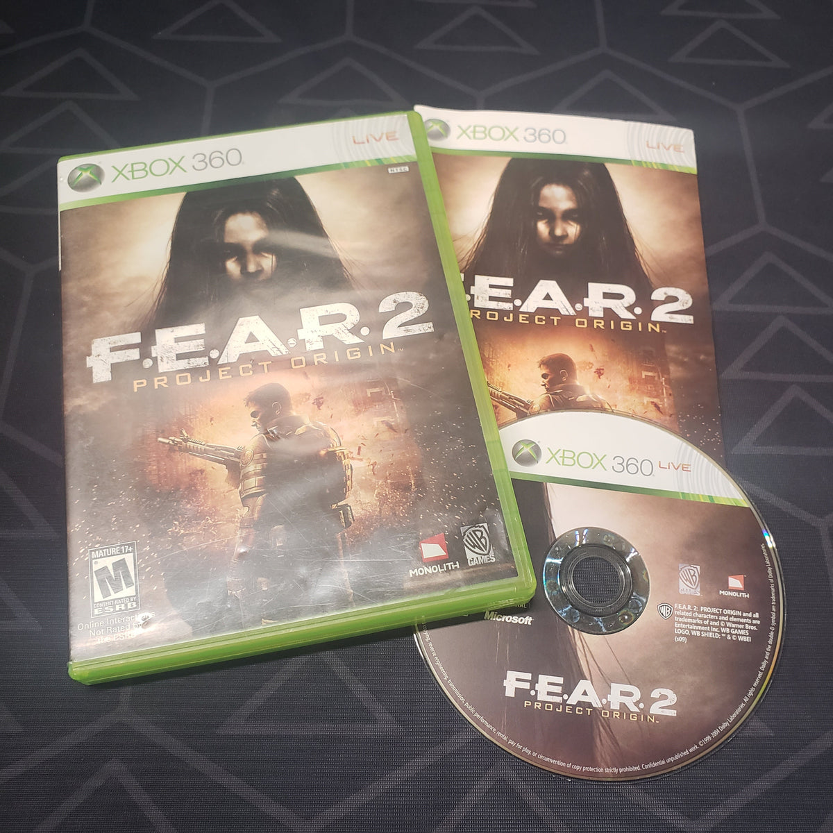 Image shows the case, manual and disc for the video game F.E.A.R. 2: Project Origin for Xbox 360