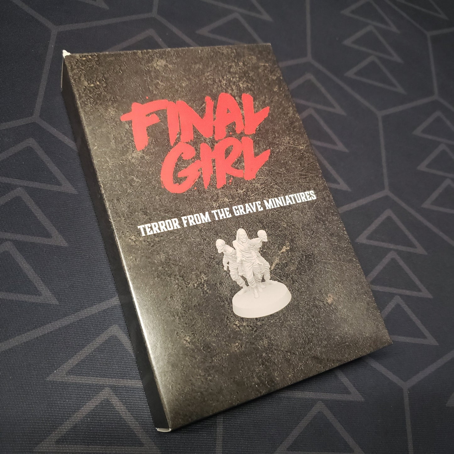 Image shows the front cover of the box of the Terror From the Grave Miniatures expansion for the board game Final Girl