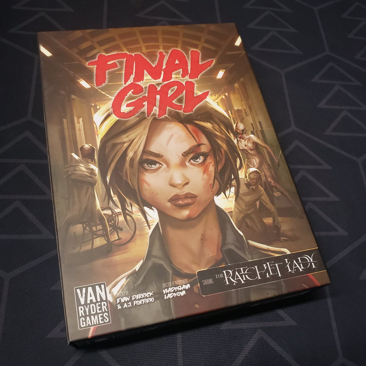 Image shows the front of the box for the Madness in the Dark Feature Film Expansion for the Final Girl board game
