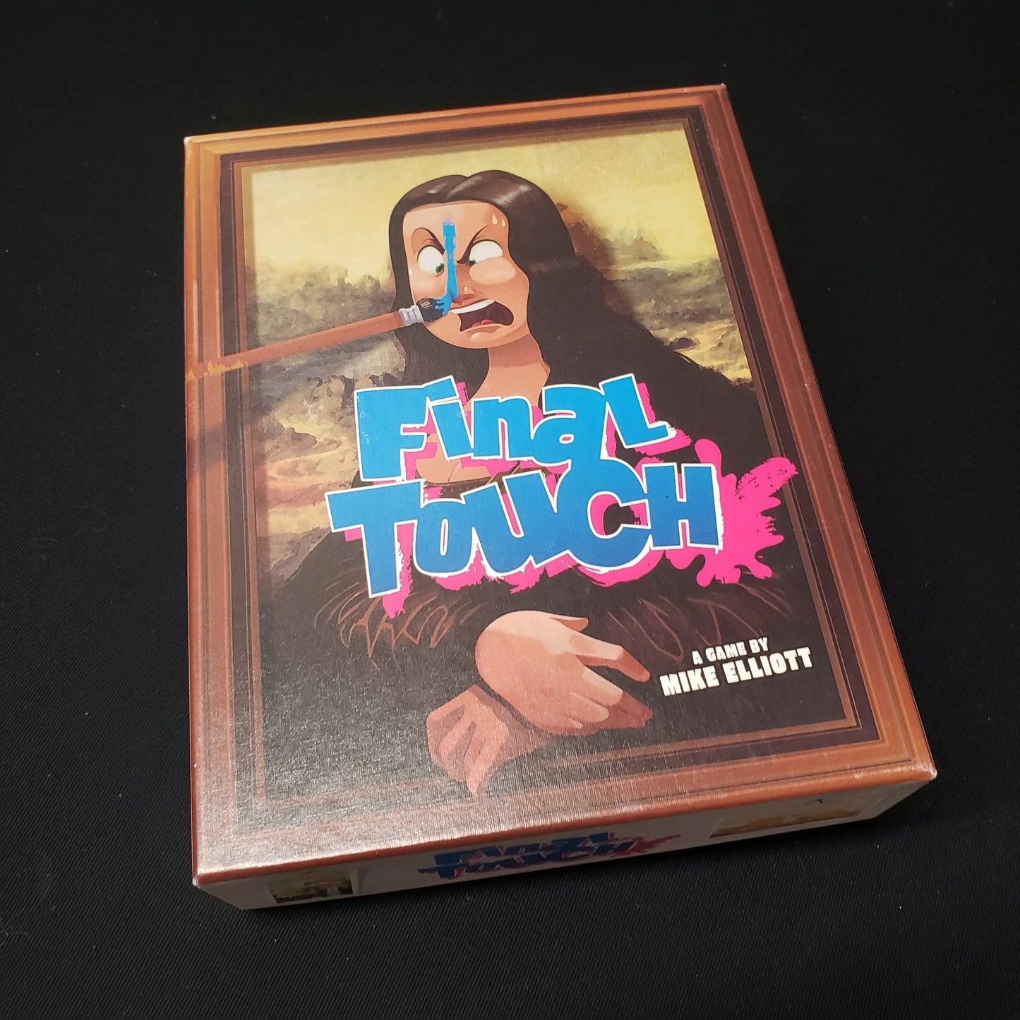 Image shows the front cover of the box of the Final Touch card game