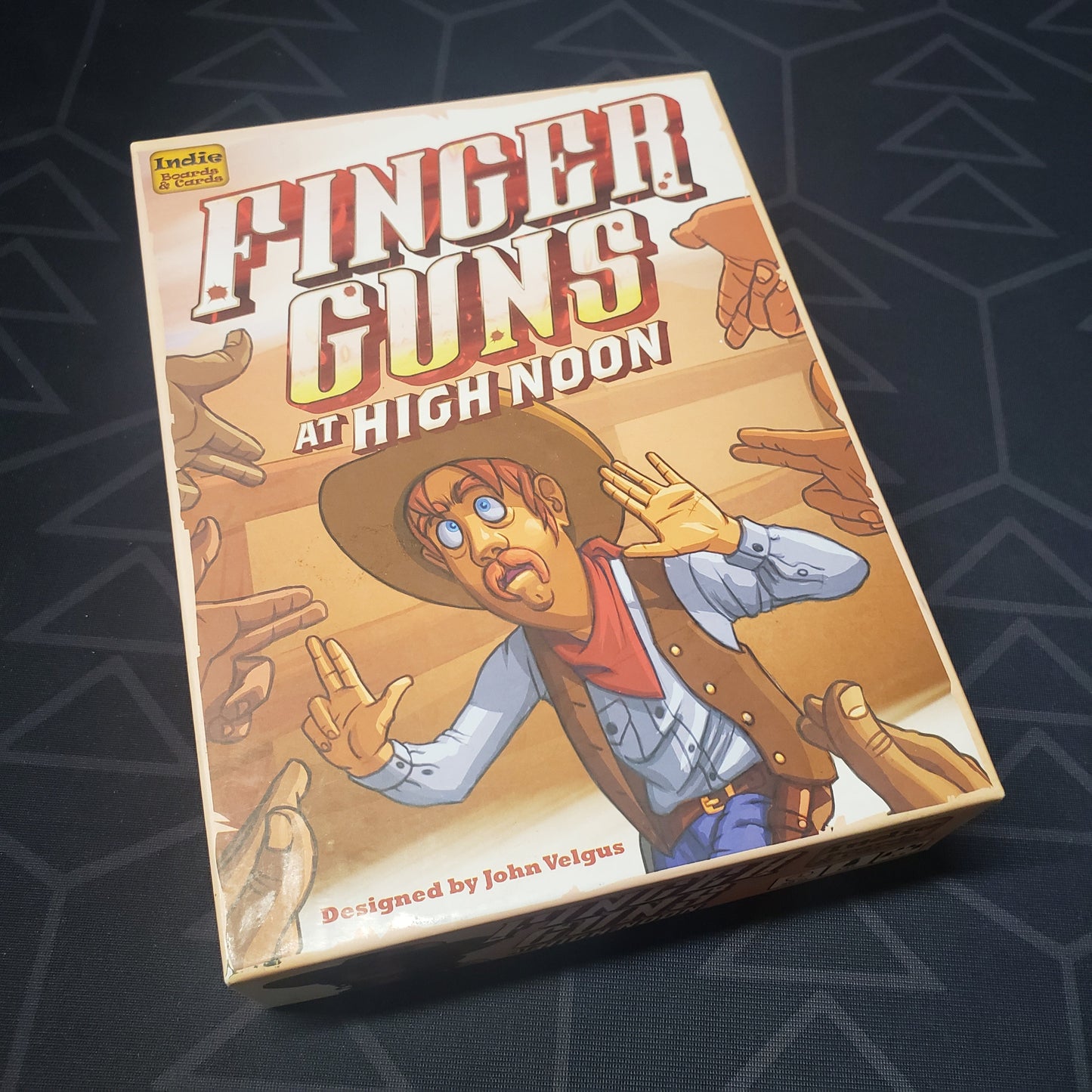 Image shows the front cover of the box for the Finger Guns at High Noon party game