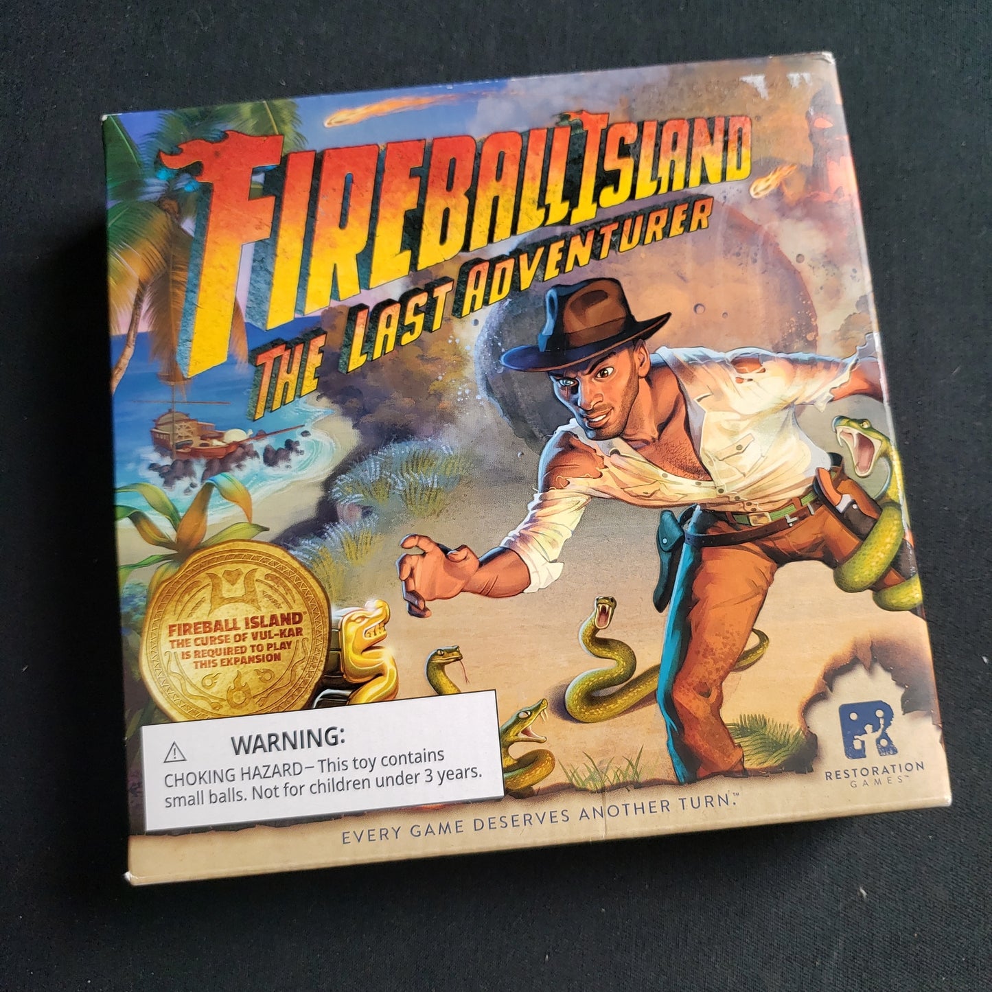 Image shows the front cover of the box of the Last Adventurer expansion for the Fireball Island board game
