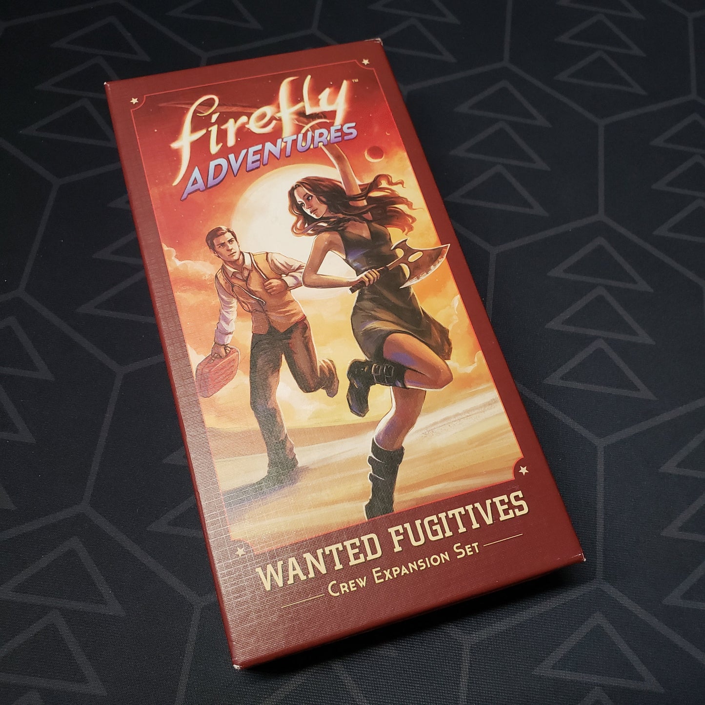 Image shows the front cover of the box of the Wanted Fugitives expansion for the board game Firefly Adventures