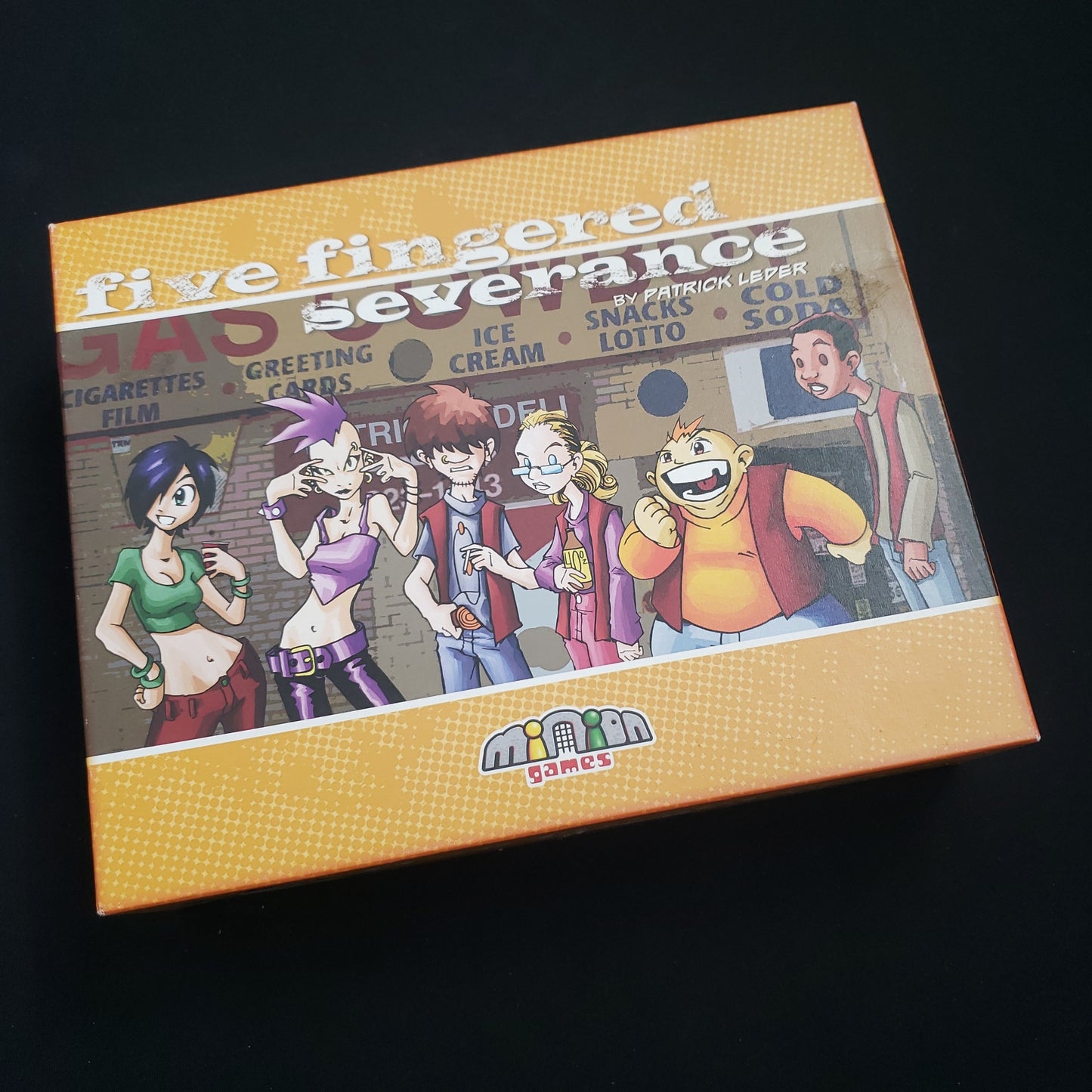 Image shows the front cover of the box of the Five Fingered Severance card game