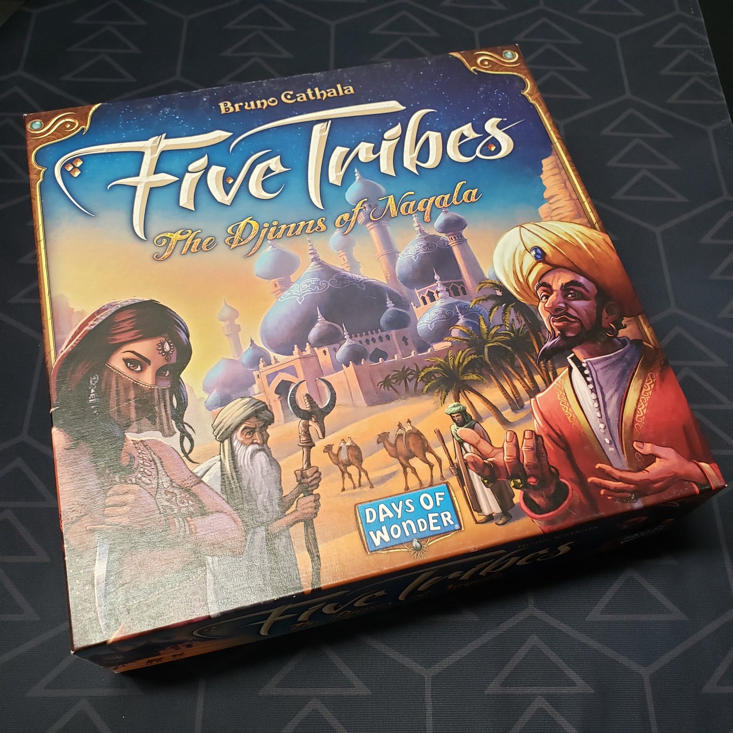 Image shows the front cover of the box of the Five Tribes board game