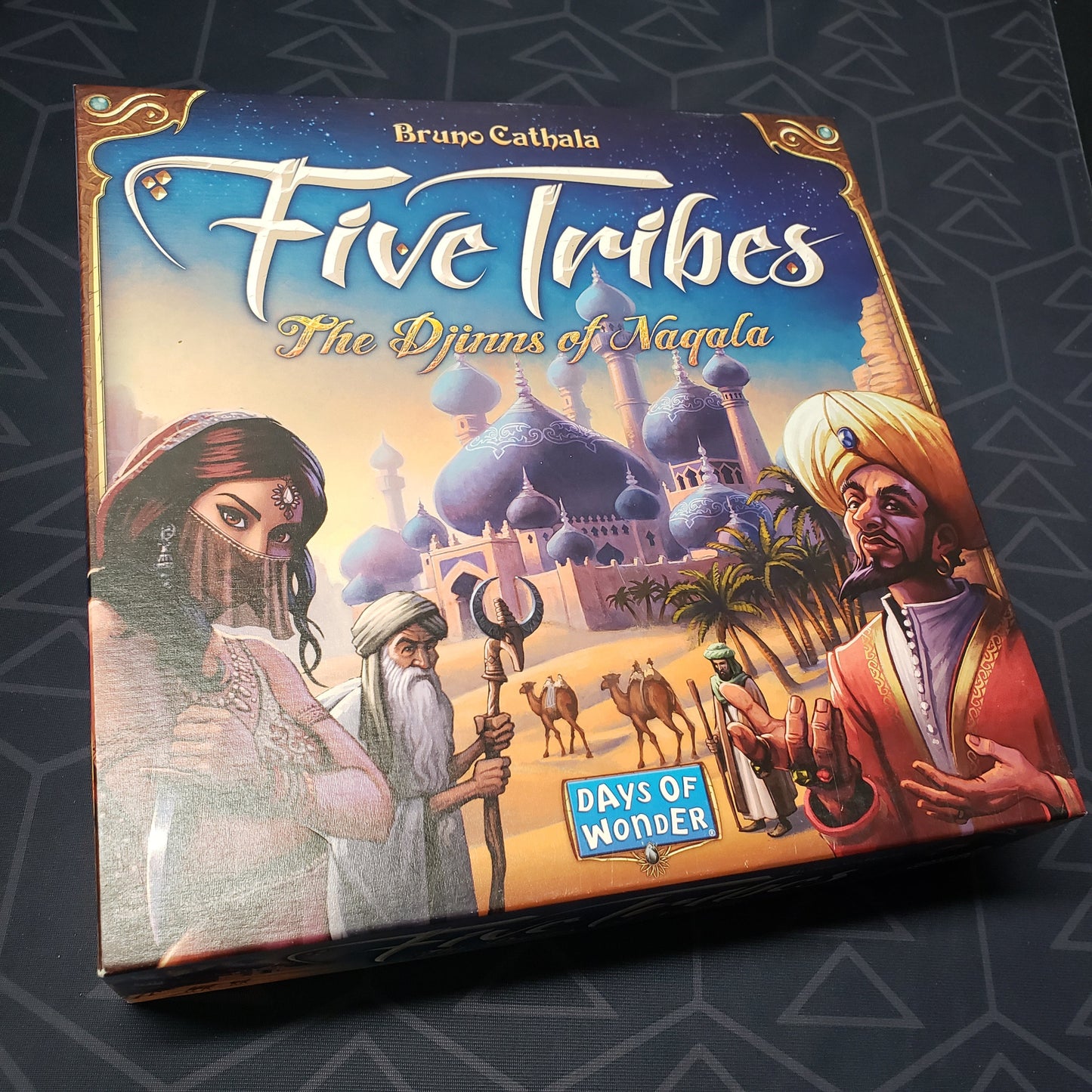Image shows the front cover of the box of the Five Tribes board game