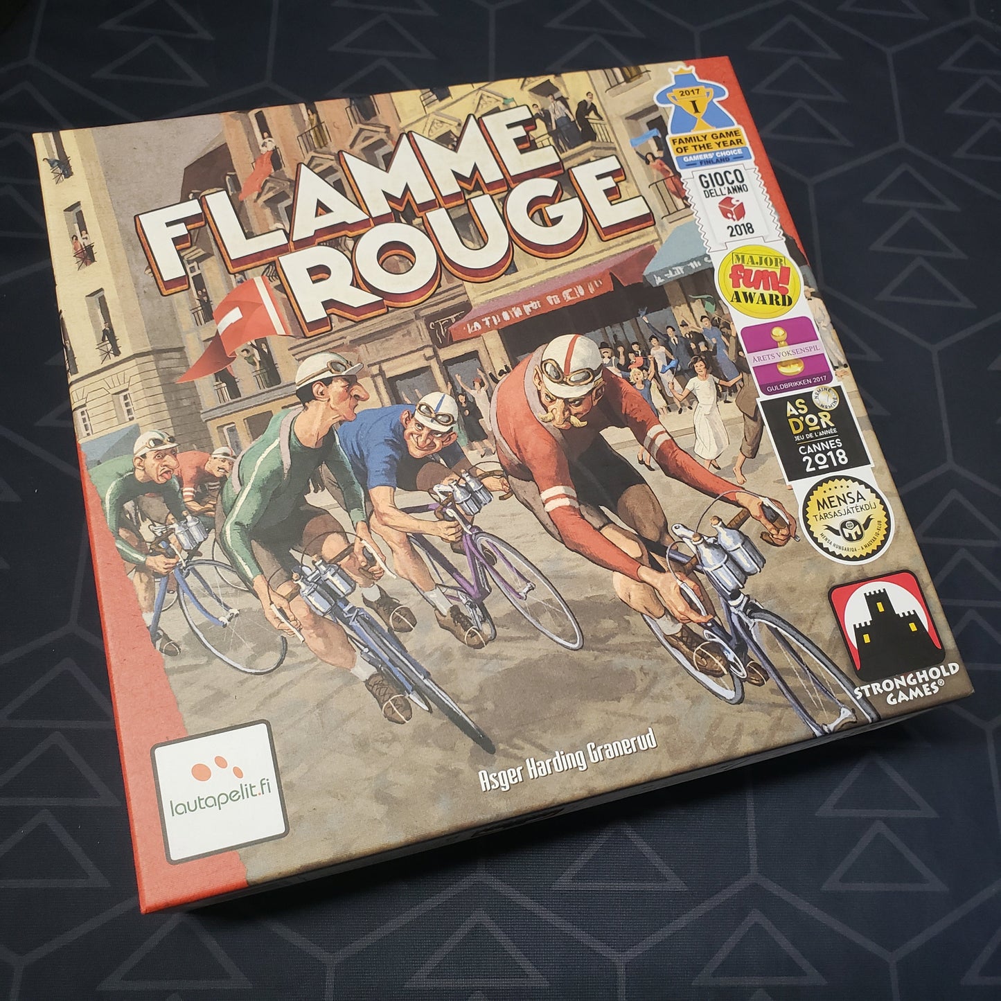 Image shows the front cover of the box of the Flamme Rouge board game