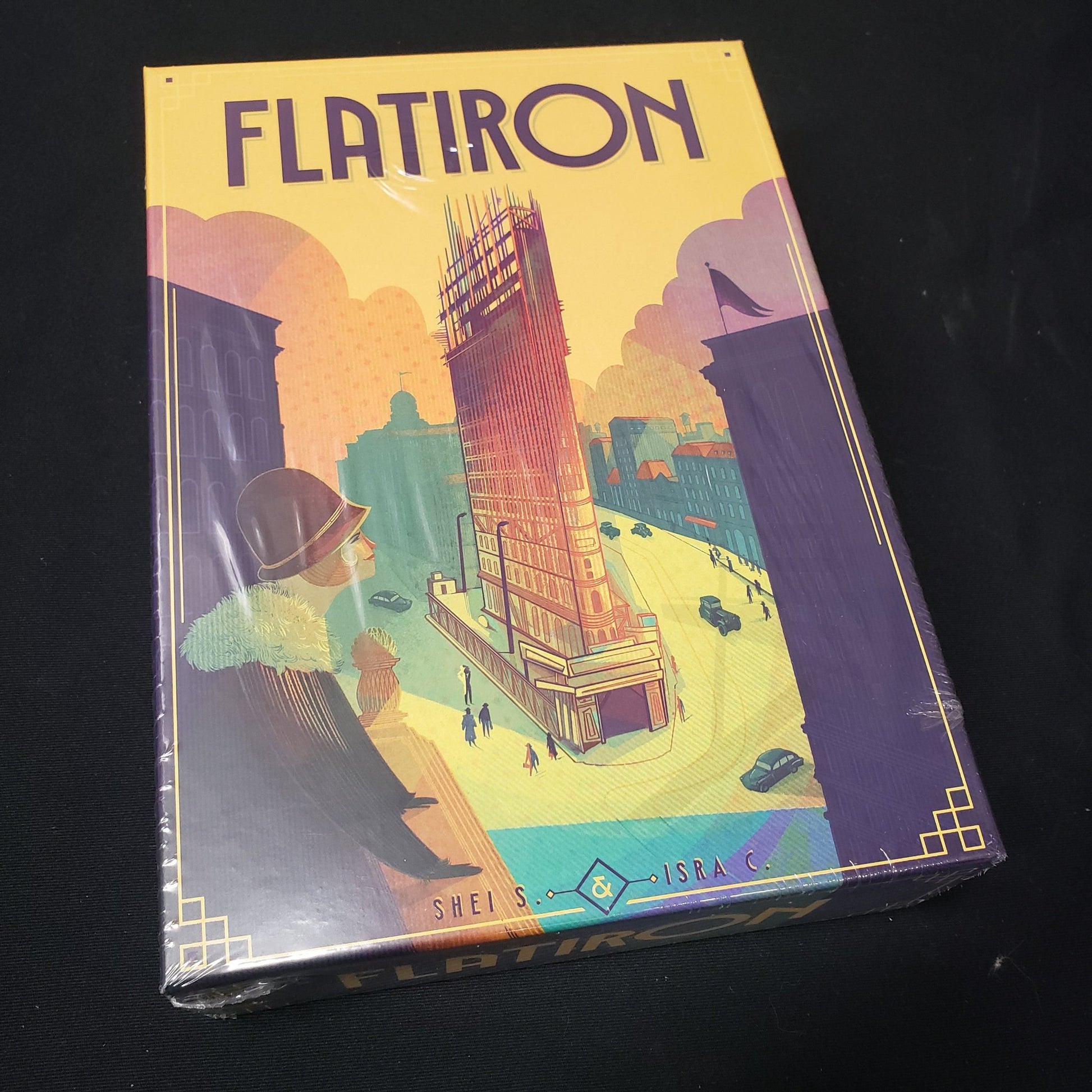 Image shows the front cover of the box of the Flatiron board game