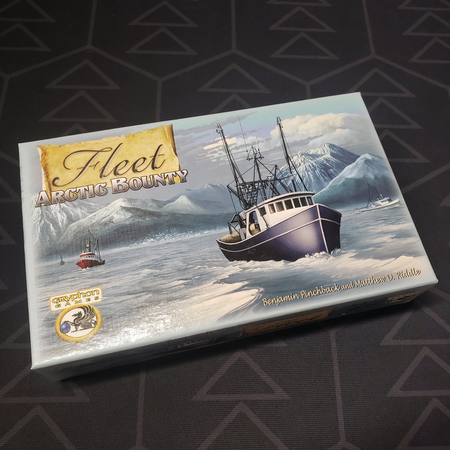 Image shows the front cover of the box of the Arctic Bounty expansion for the card game Fleet