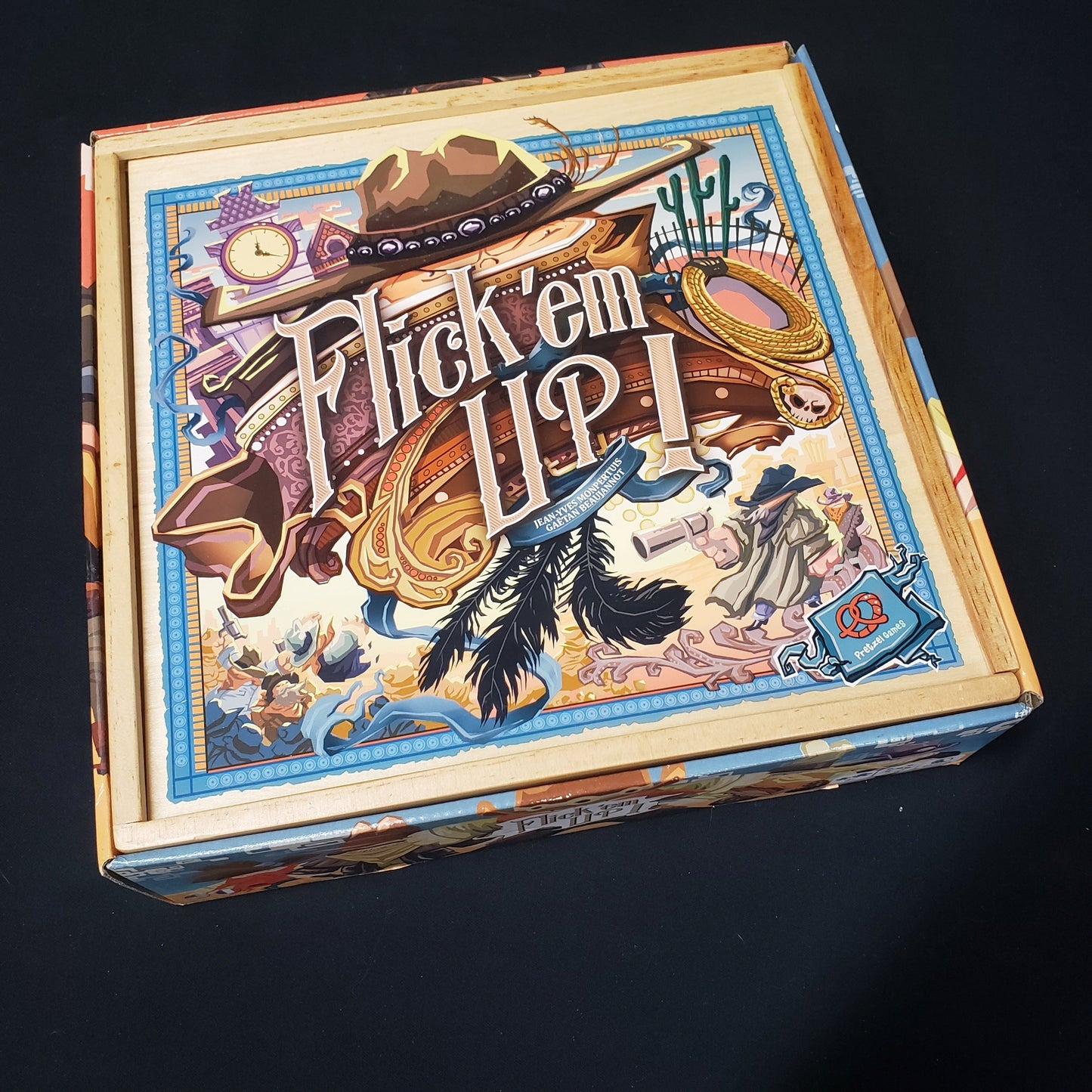 Image shows the front cover of the box of the Flick 'Em Up! board game