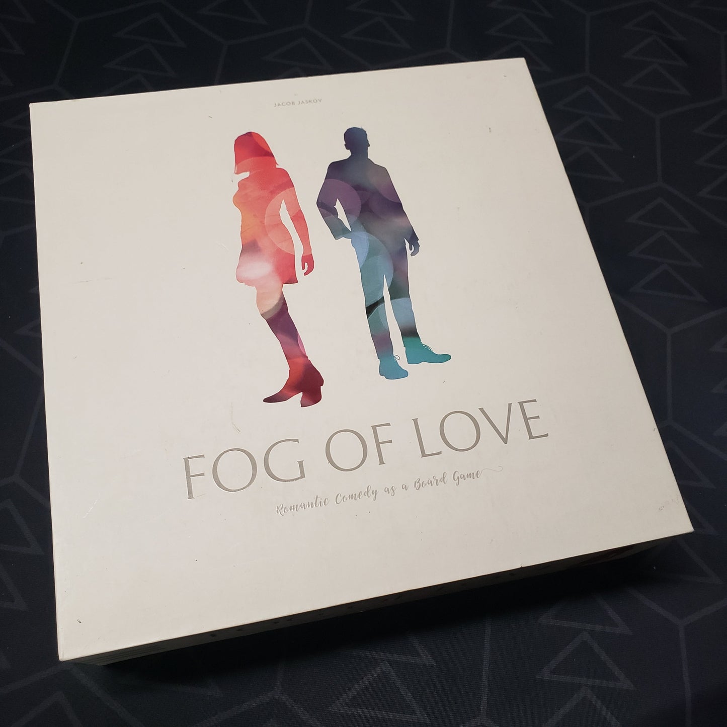 Image shows the front cover of the box of the Fog of Love board game