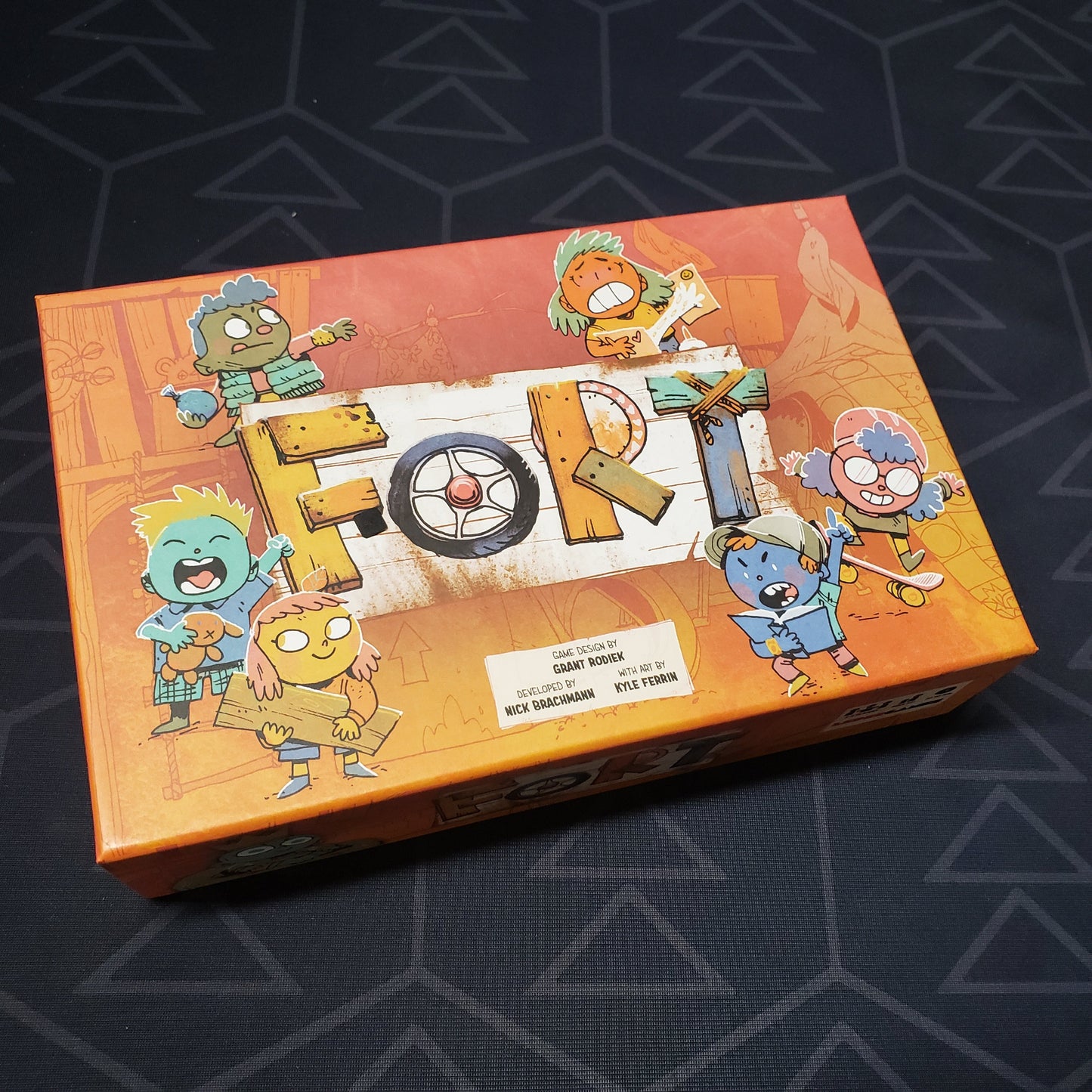 Image shows the front cover of the box of the Fort card game