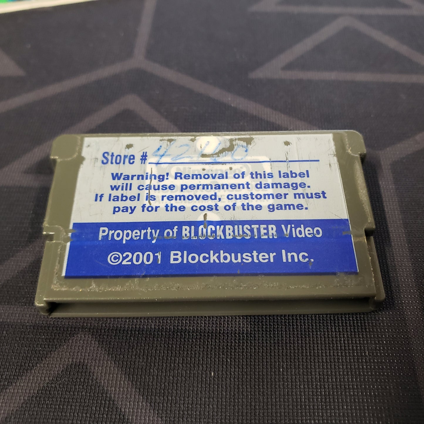 Image shows a Blockbuster sticker on the back of the cartridge for the video game Fortress for Nintendo Game Boy Advance