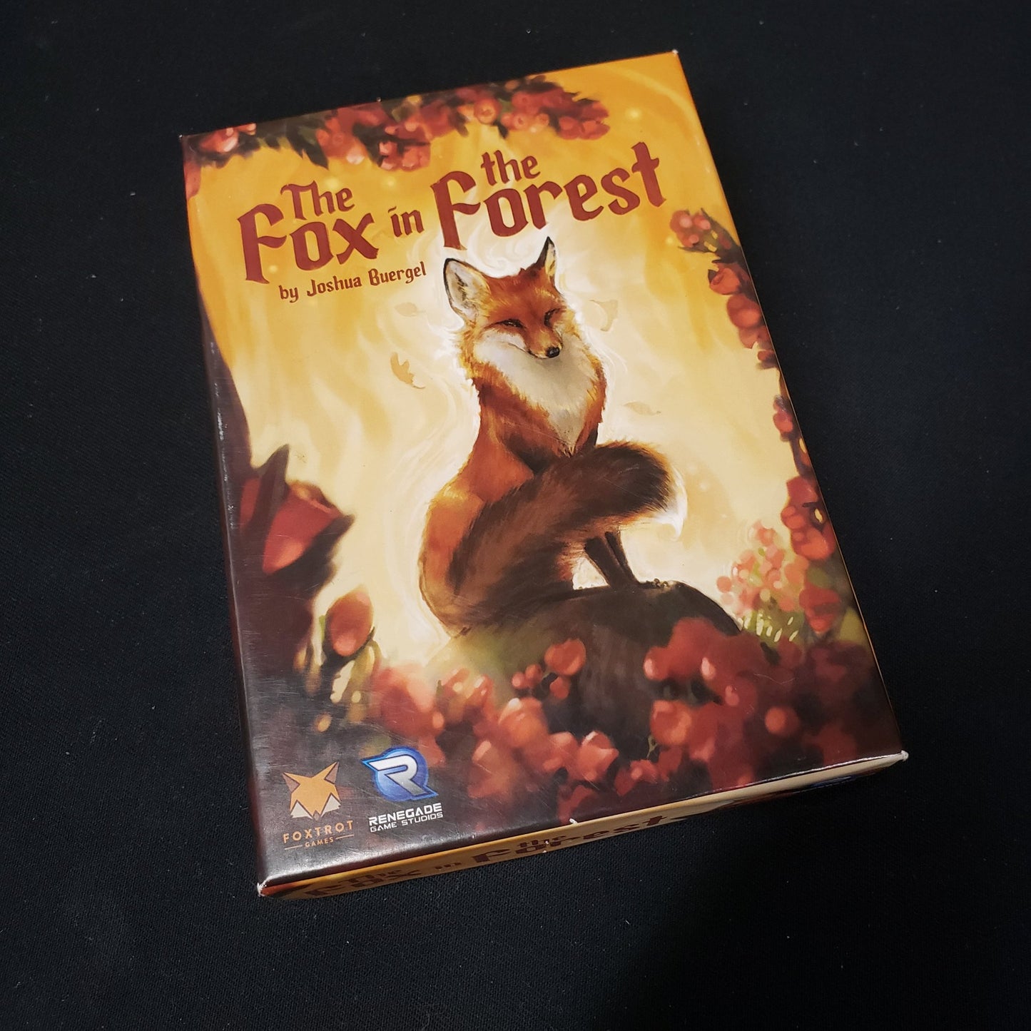 Image shows the front cover of the box of the card game The ox in the Forest