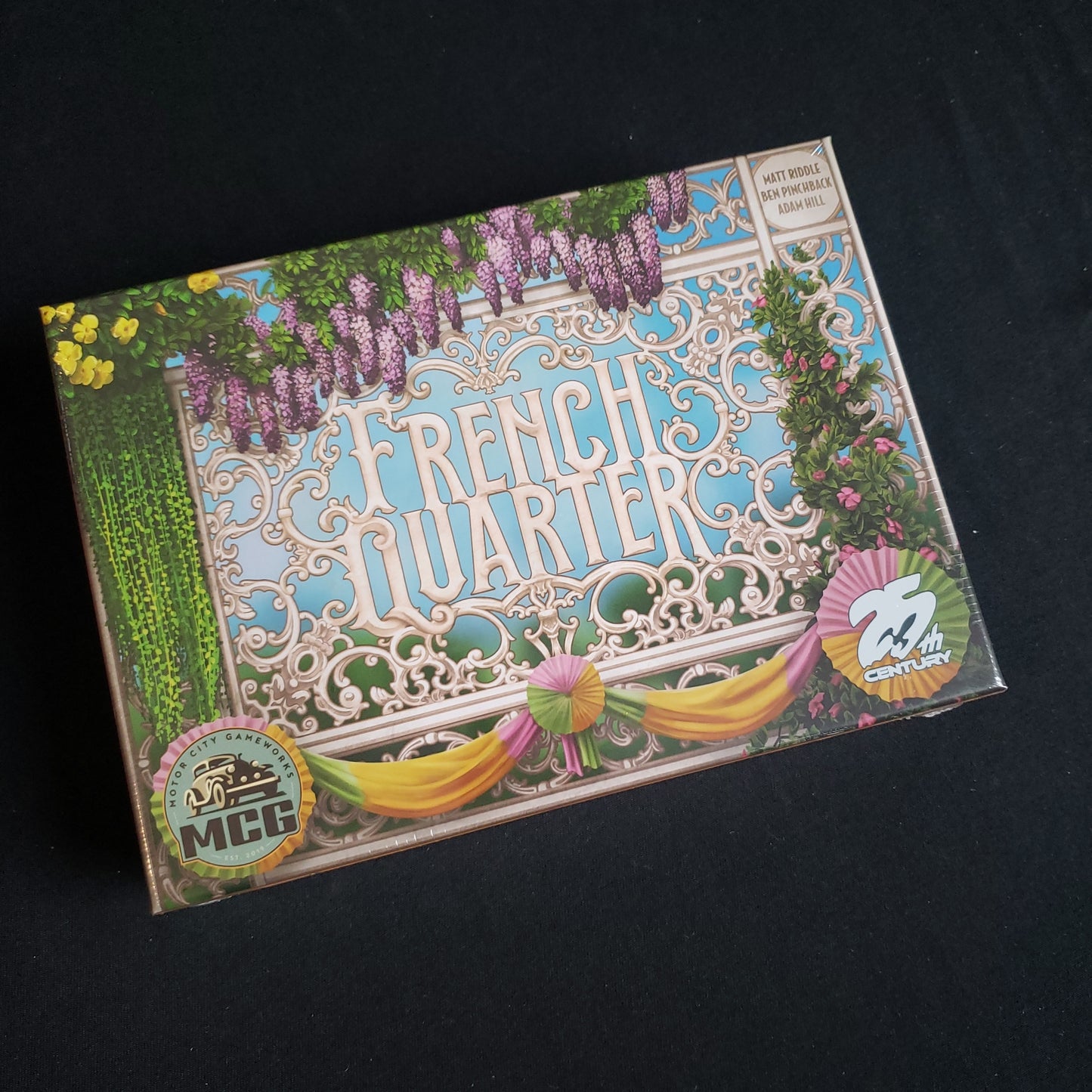 Image shows the front cover of the box of the French Quarter board game