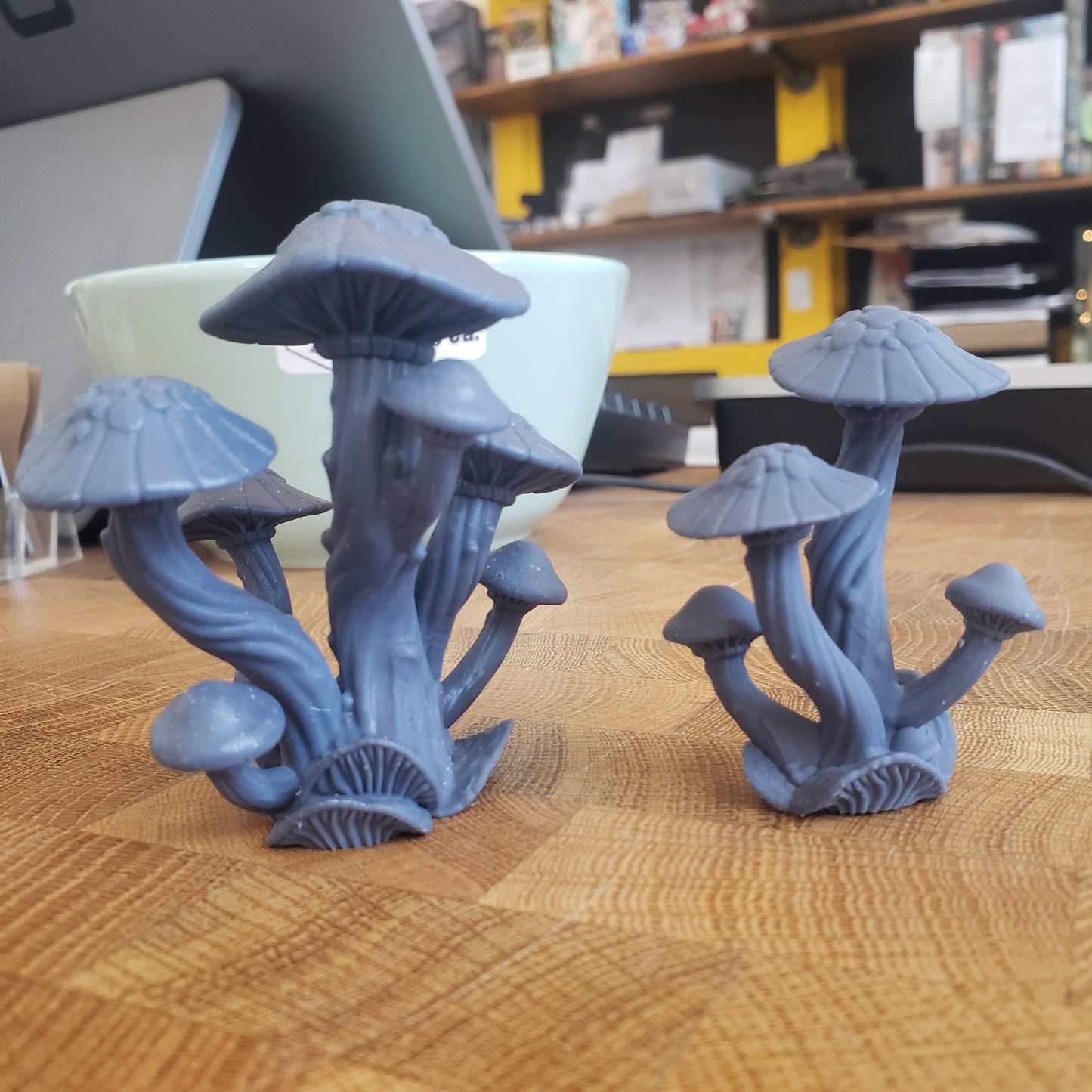 Image is a photo of two different sizes of 3D printed mushroom cluster gaming terrain printed in-house at All Systems Go